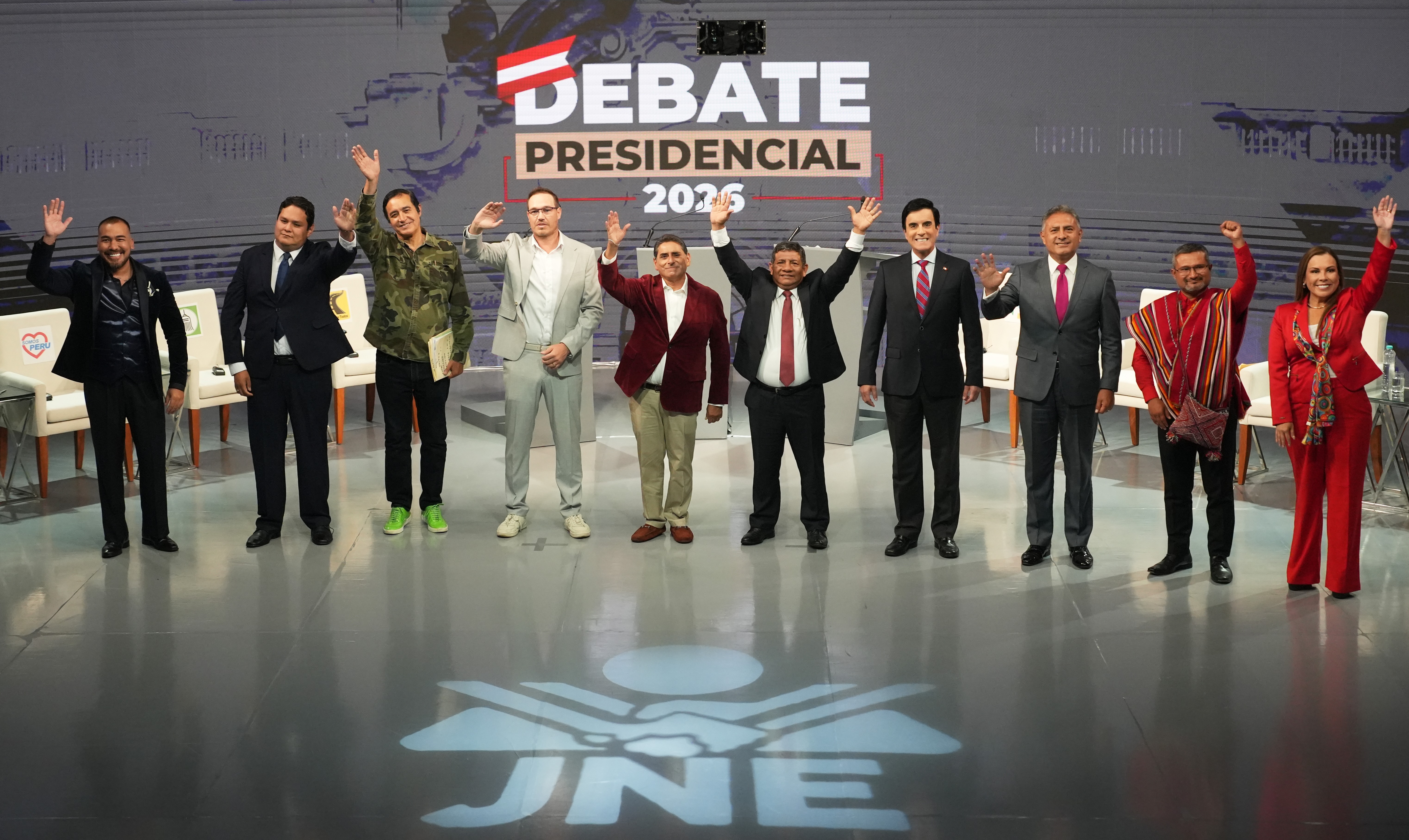 From left, presidential candidates Alvaro Paz de la Barra, Enrique Valderrama, Alex Gonzales, George Forsyth, Carlos Alvarez, Walter Chirinos, Carlos Espa, Carlos Jaico, Ronald Atencio, Fiorella Molinelli wave to reporters upon arriving at a presidential debate ahead of the April 12 election in Lima, Peru, Monday, March 30, 2026. (AP Photo/Guadalupe Pardo)