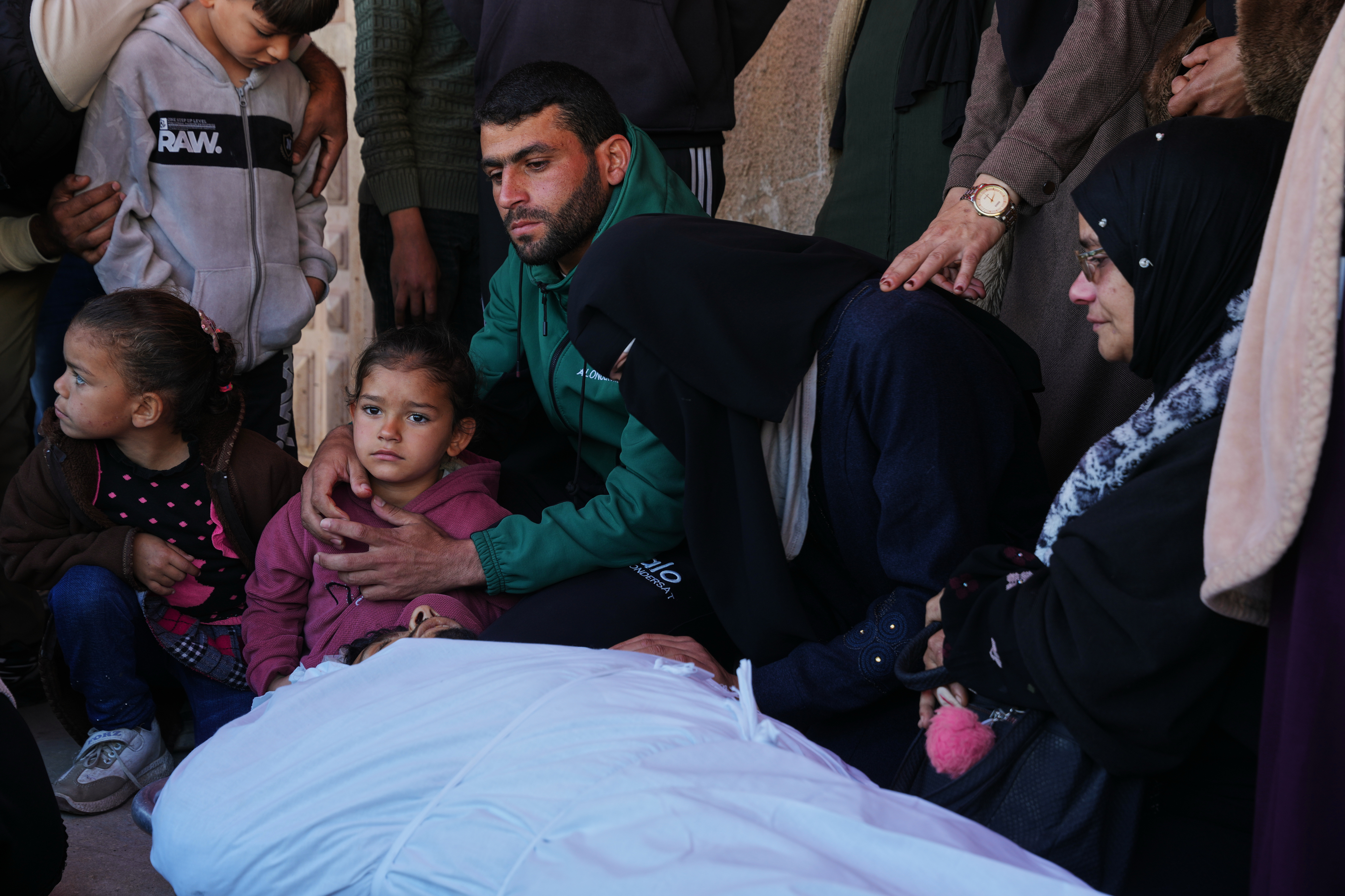 Relatives mourn over the body of Palestinian Mohamed Abu al-Rous, who was killed in an Israeli attack, during his funeral in Deir el-Balah, central Gaza
