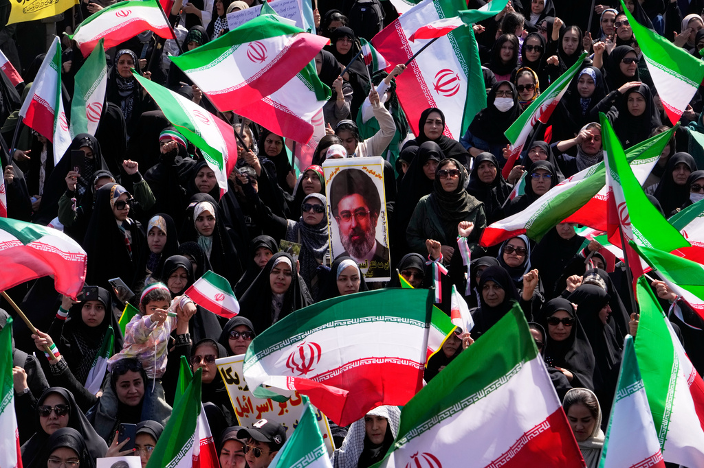 Women hold Iranian flags and a portrait of Supreme Leader Ayatollah Mojtaba Khamenei during a state-organised rally in support of the supreme leader marking National Girl’s Day in Tehran, Iran, Friday, April 17, 2026