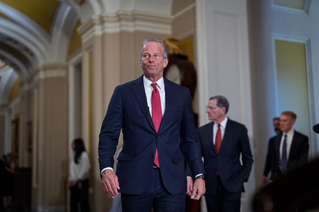 Senate Majority Leader John Thune emerges from a meeting in the US Capitol