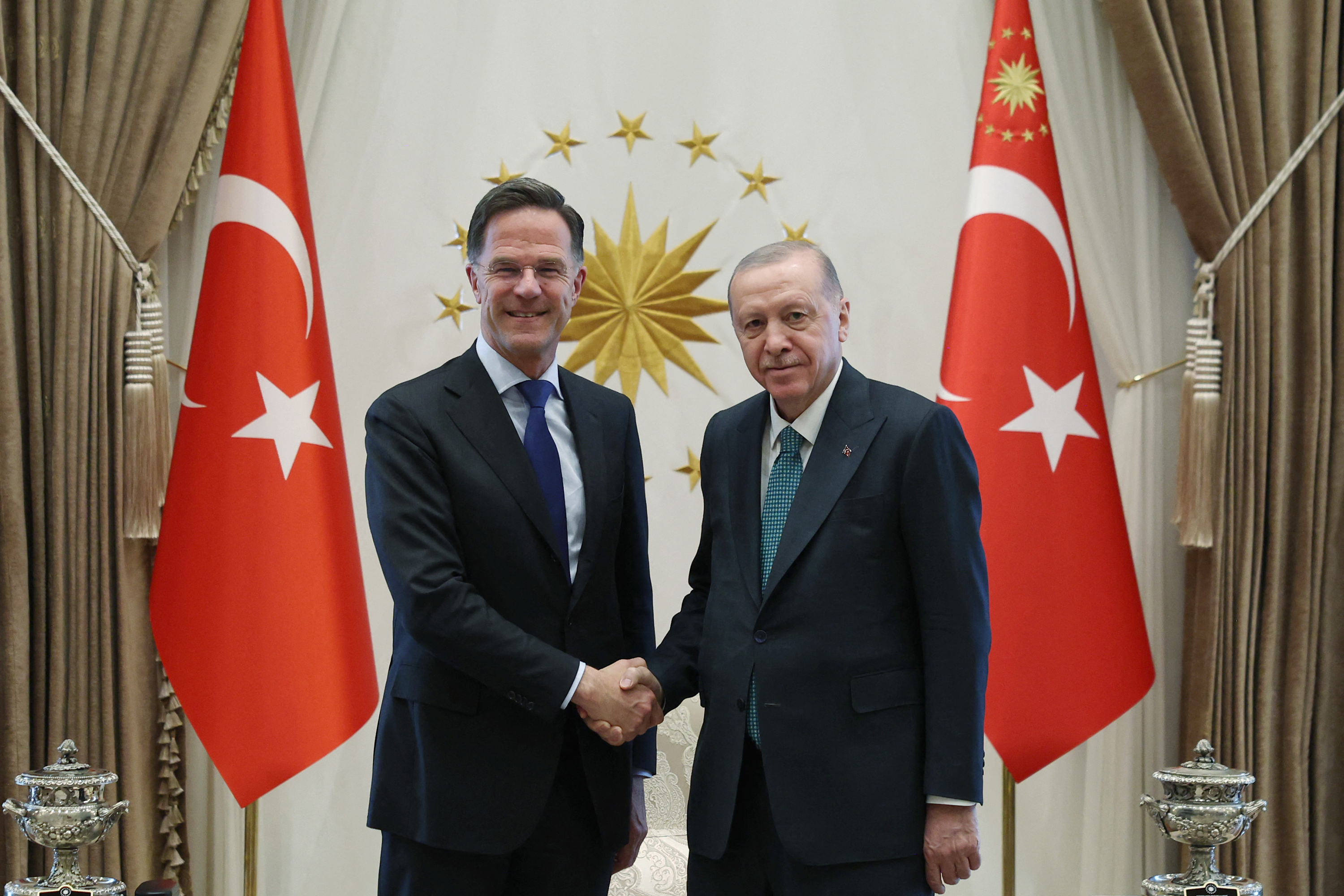 This handout photograph taken and released by Turkish Presidential Press Office on April 22, 2026, shows Turkey's President Recep Tayyip Erdogan (R) shaking hands with NATO Secretary General Mark Rutte at the Presidential Complex in Ankara.