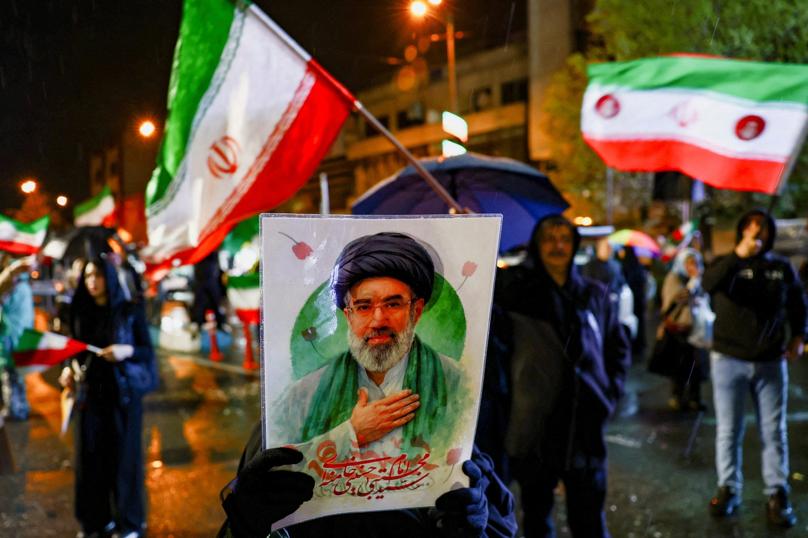 A woman holds a poster depicting Iran&rsquo;s new Supreme Leader Mojtaba Khamenei during an anti-U.S. and anti-Israeli rally, amid the U.S.-Israeli conflict with Iran, in Tehran, Iran on March 26, 2026. [Majid Asgaripour/West Asia News Agency via Reuters]