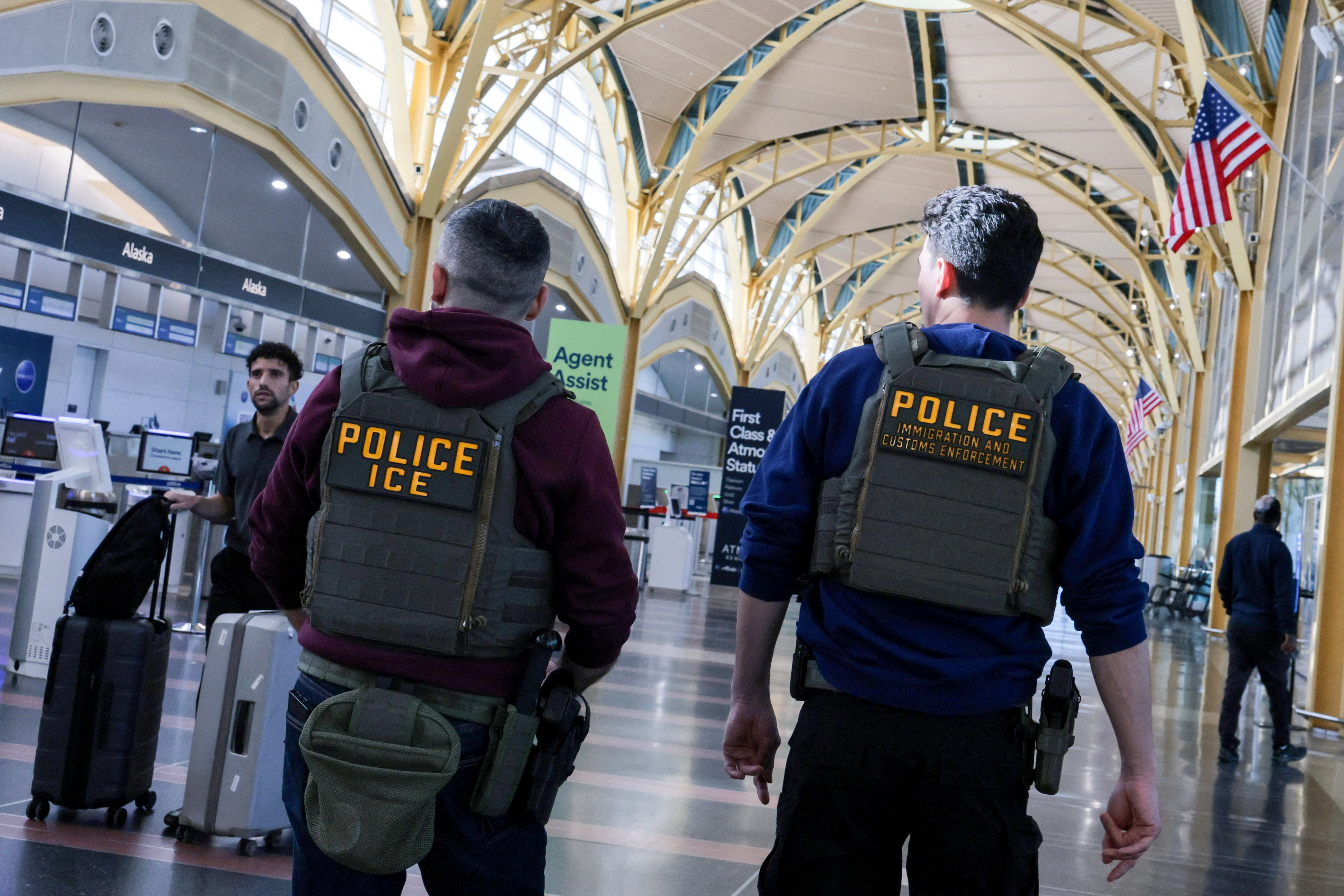FILE PHOTO: U.S. Immigration and Customs Enforcement (ICE) agents patrol at Washington Reagan National Airport in Arlington, Virginia, U.S., March 24, 2026. REUTERS/Jonathan Ernst/File Photo