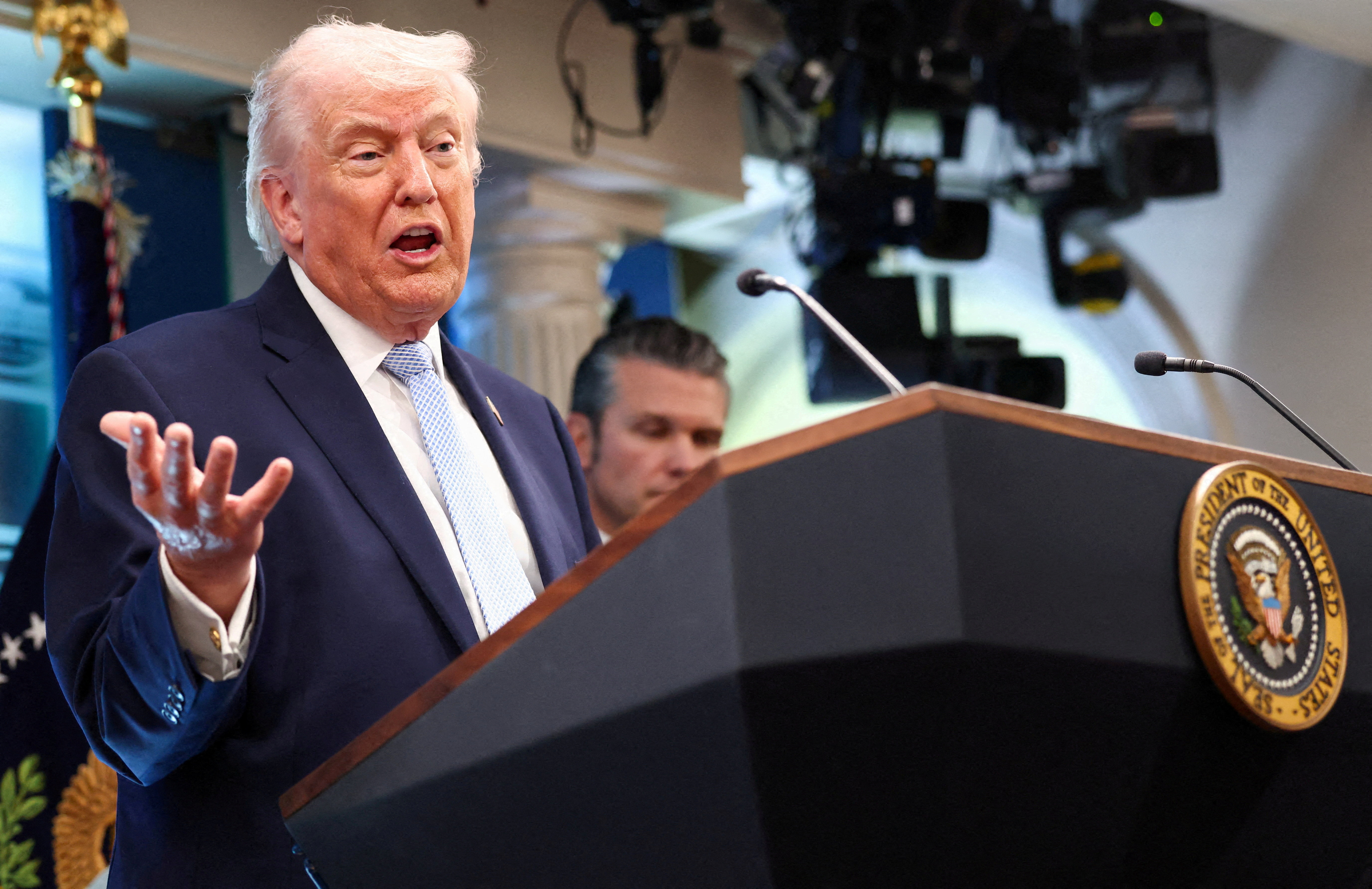 FILE PHOTO: U.S. President Donald Trump, flanked by Secretary of Defense Pete Hegseth, speaks during a press conference in the James S. Brady Press Briefing Room at the White House in Washington, D.C., U.S., April 6, 2026. REUTERS/Kevin Lamarque/File Photo
