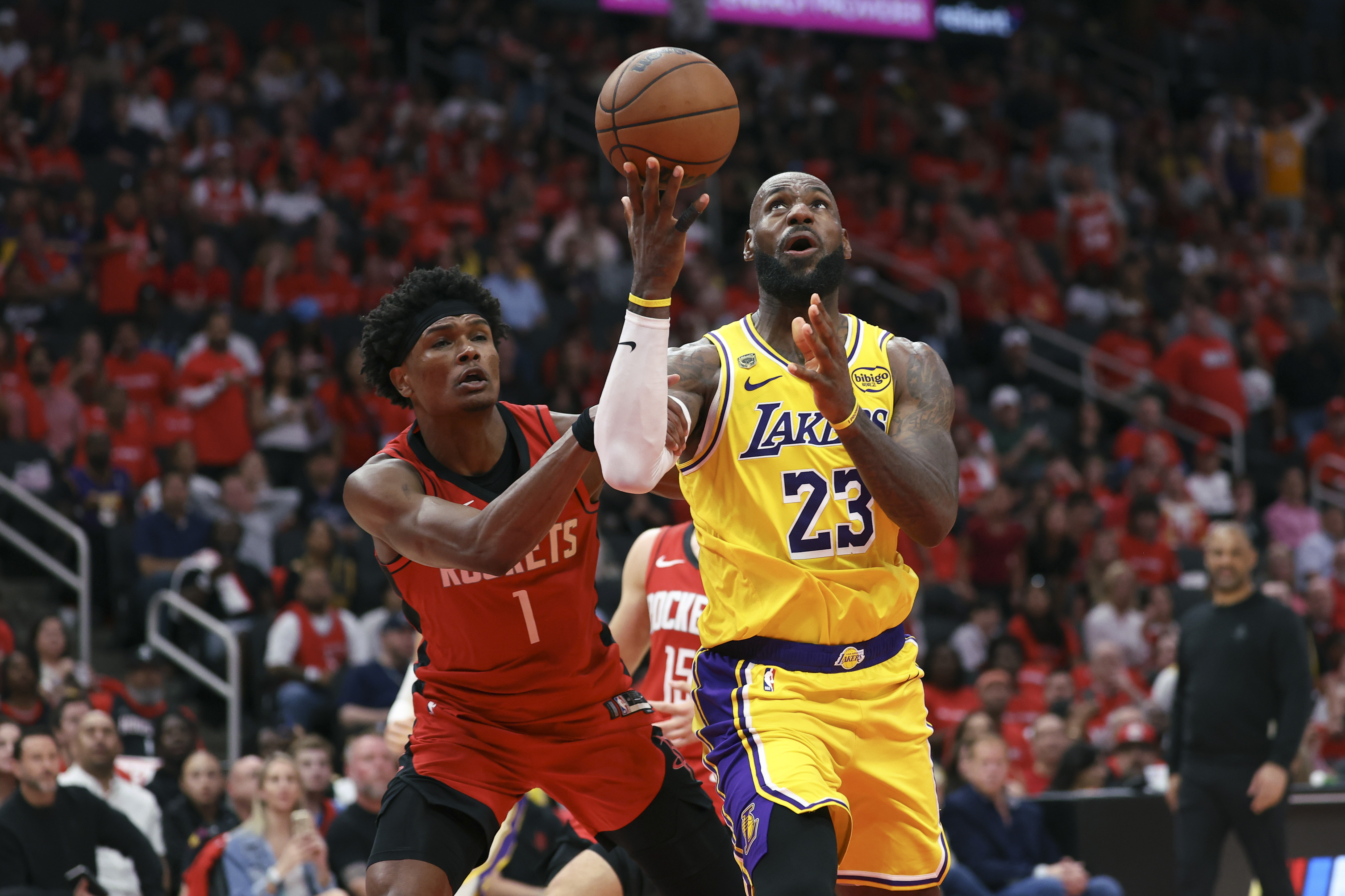 Apr 24, 2026; Houston, Texas, USA; Los Angeles Lakers forward LeBron James (23) attempts to score as Houston Rockets guard/forward Amen Thompson (1) defends during the third quarter during game three of the first round of the 2026 NBA Playoffs at Toyota Center. Mandatory Credit: Troy Taormina-Imagn Images