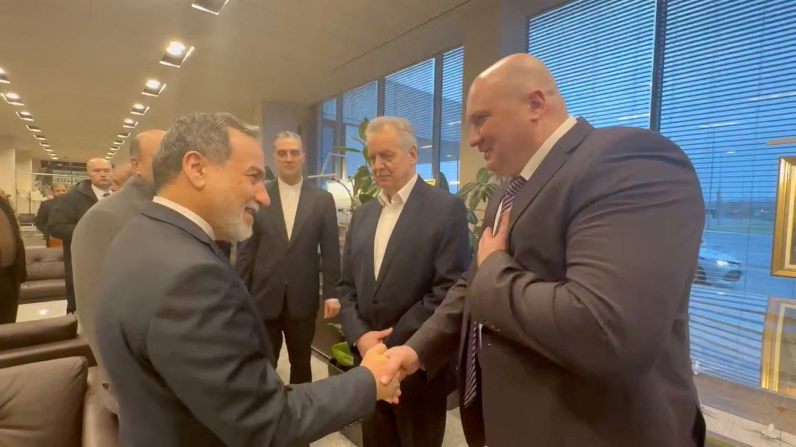 Iran's Foreign Minister Abbas Araghchi is greeted by officials during his visit to Russia