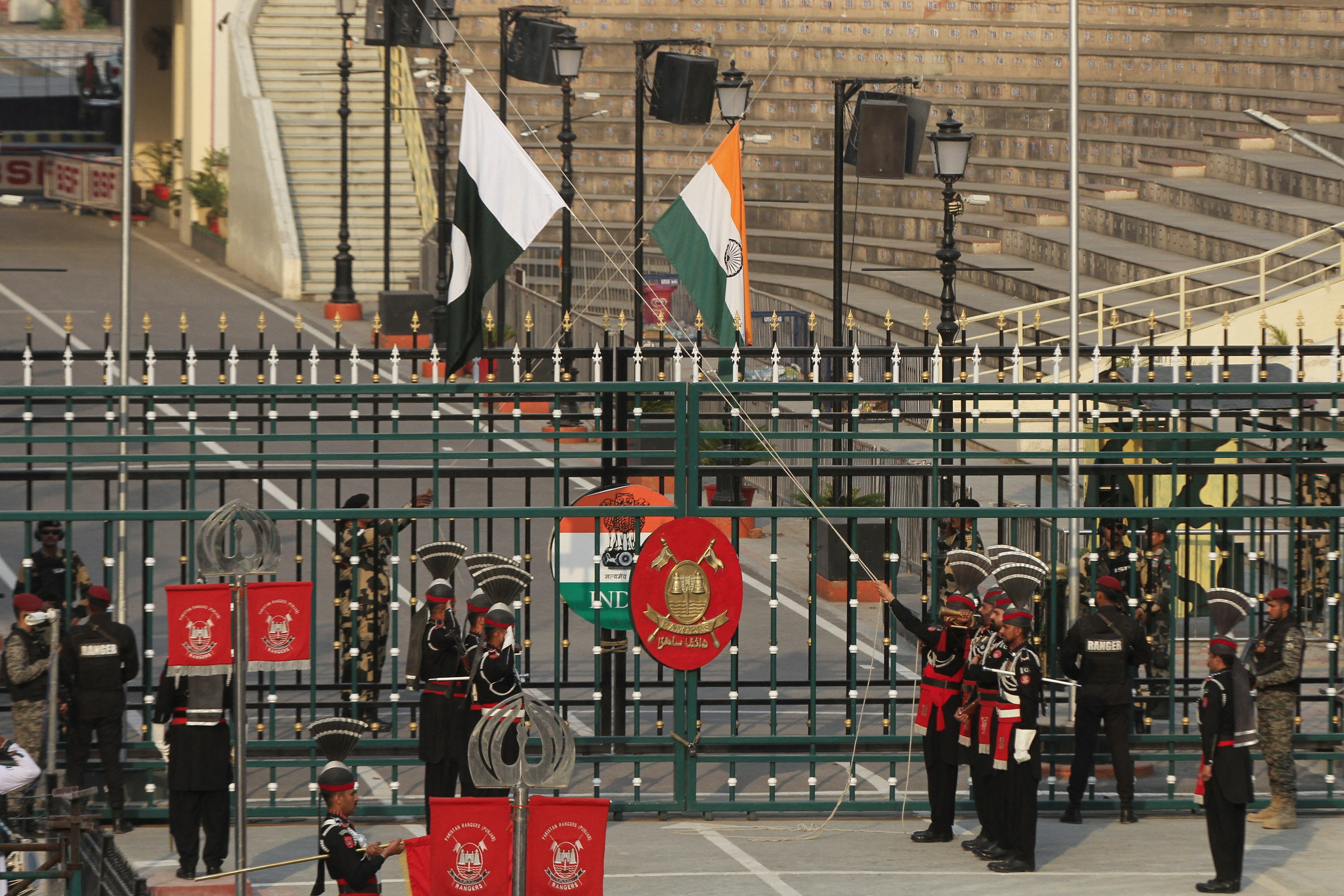 Pakistan Rangers and Indian Border Security Force soldiers lower their national flags.