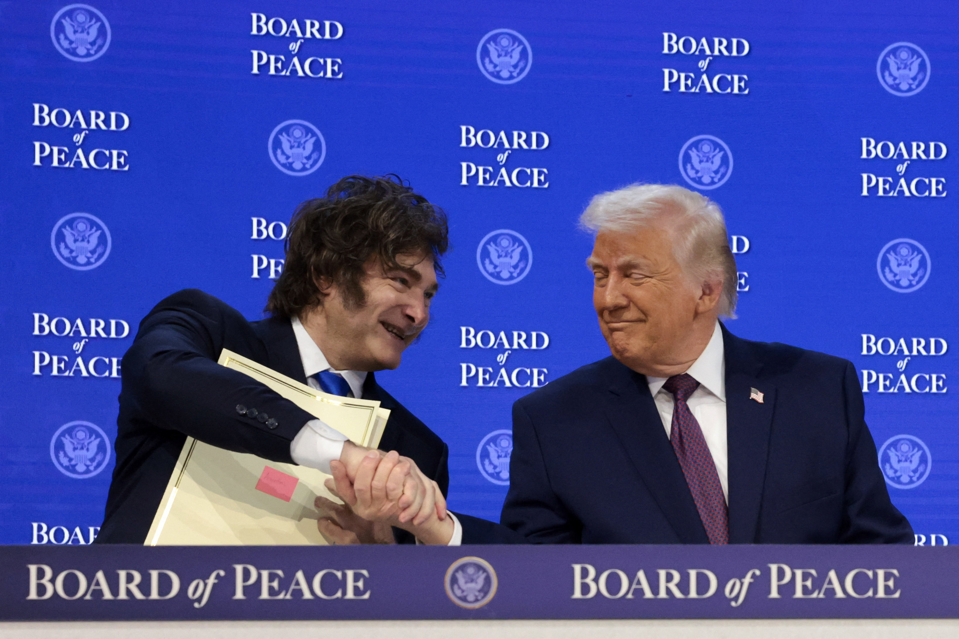 US President Donald Trump shakes hands with Argentina's President Javier Milei