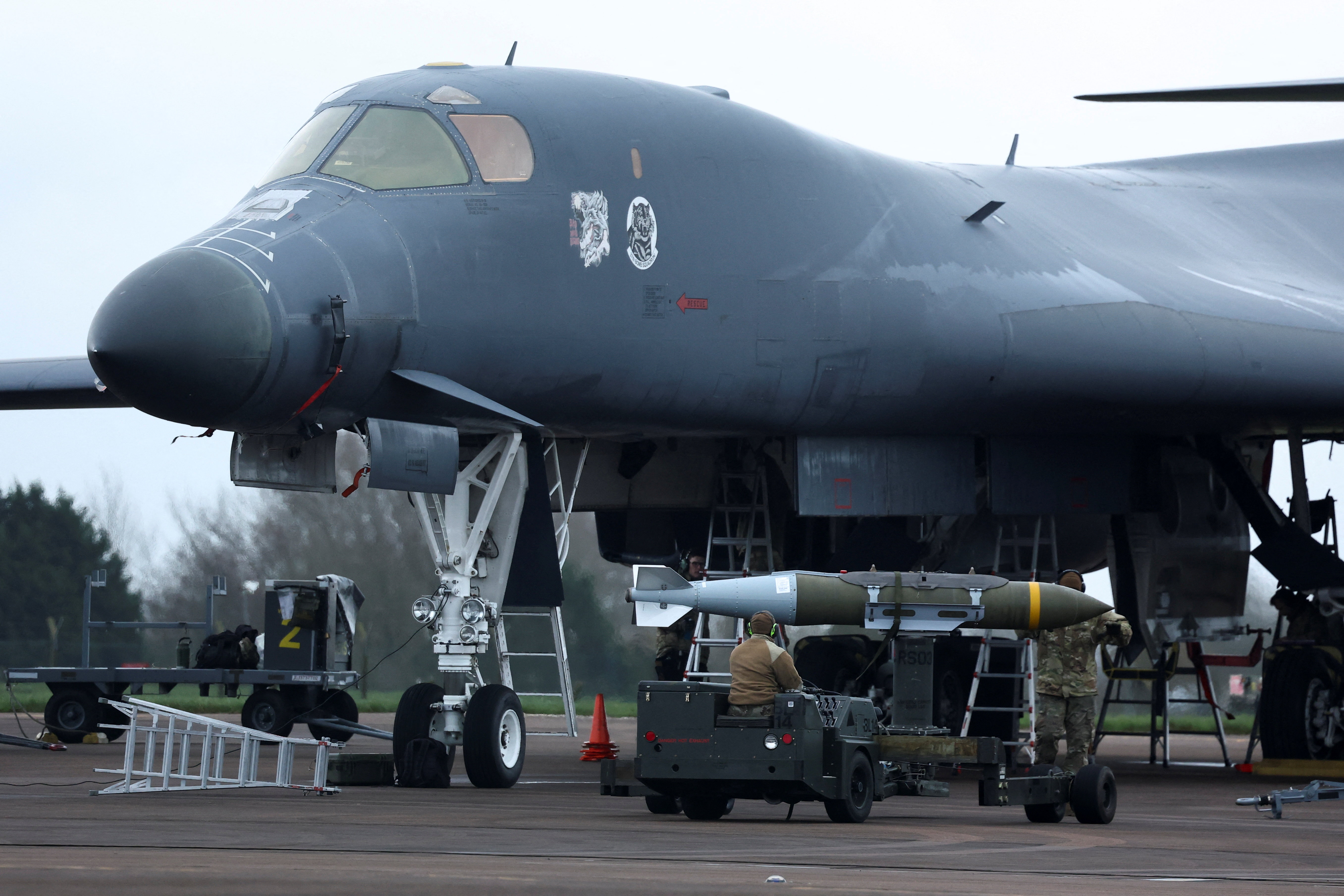 U.S. Air Force (USAF) personnel load munitions to a B-1 bomber at RAF Fairford airbase,