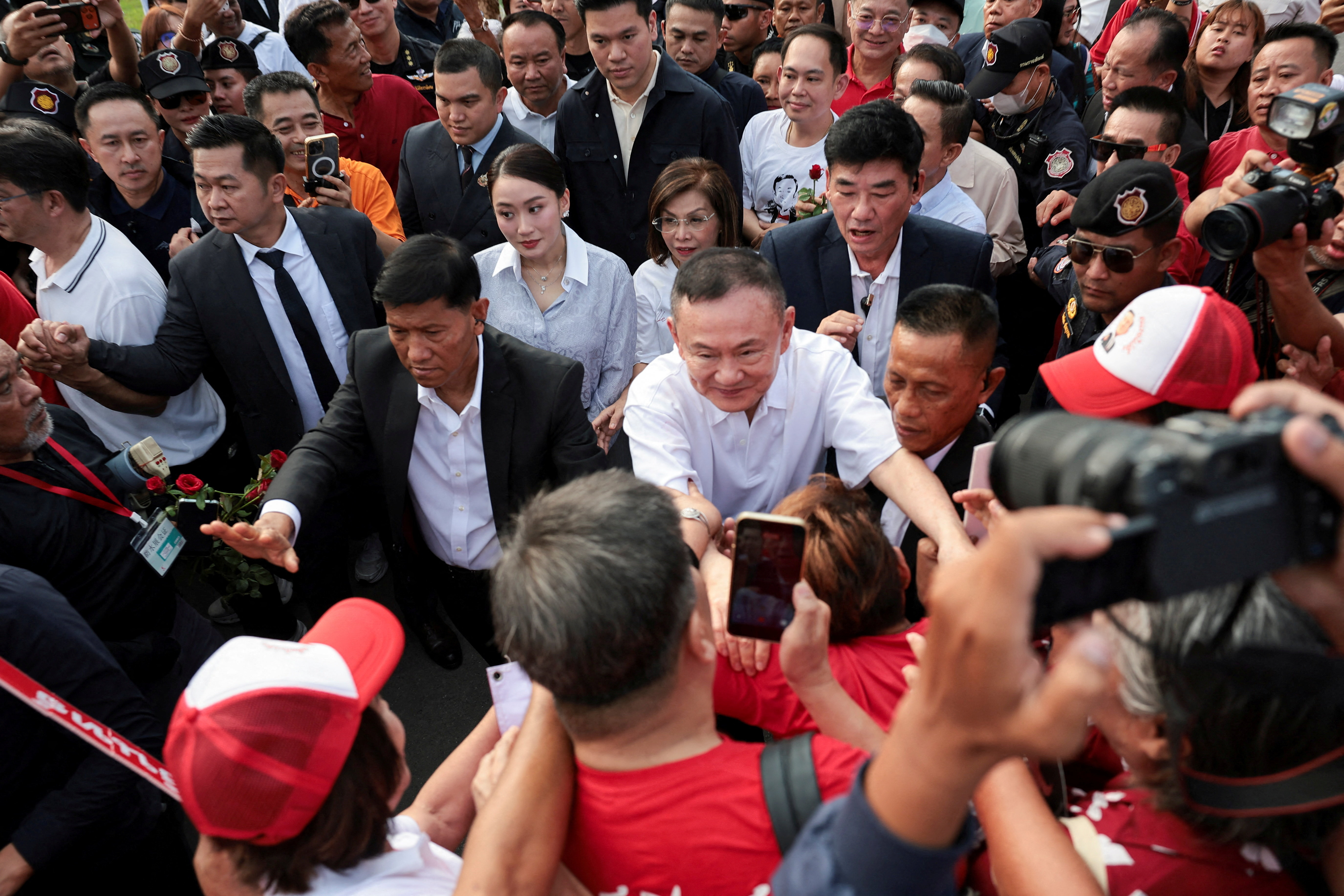 Former Thai Prime Minister Thaksin Shinawatra interacts with supporters following his release on parole after serving eight months of his one-year sentence at Klong Prem Central Prison, in Bangkok, Thailand, May 11, 2026.