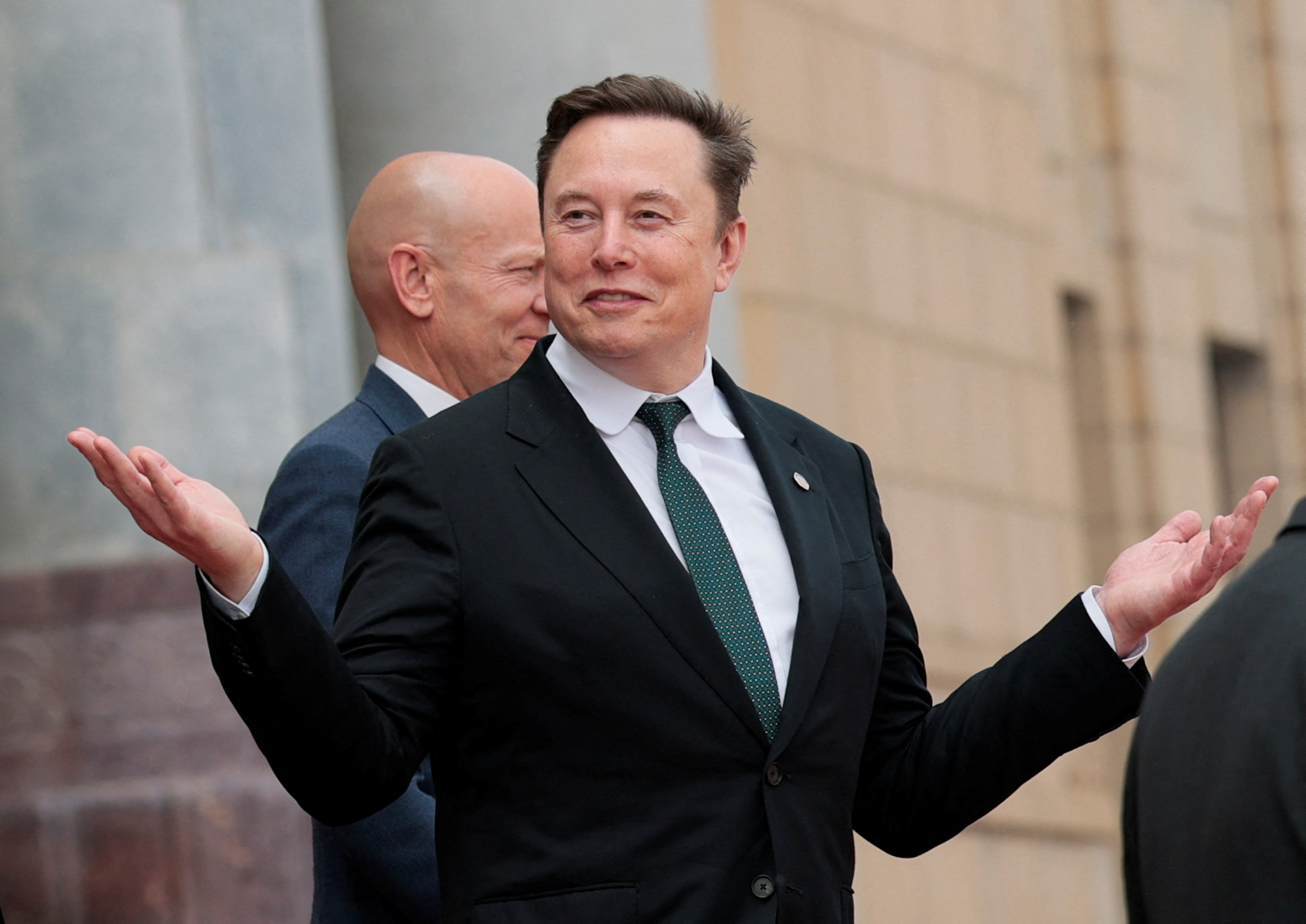 Elon Musk gestures as he leaves after attending a welcome ceremony for U.S. President Donald Trump with Chinese President Xi Jinping at the Great Hall of the People in Beijing, China, May 14, 2026. REUTERS/Evan Vucci
