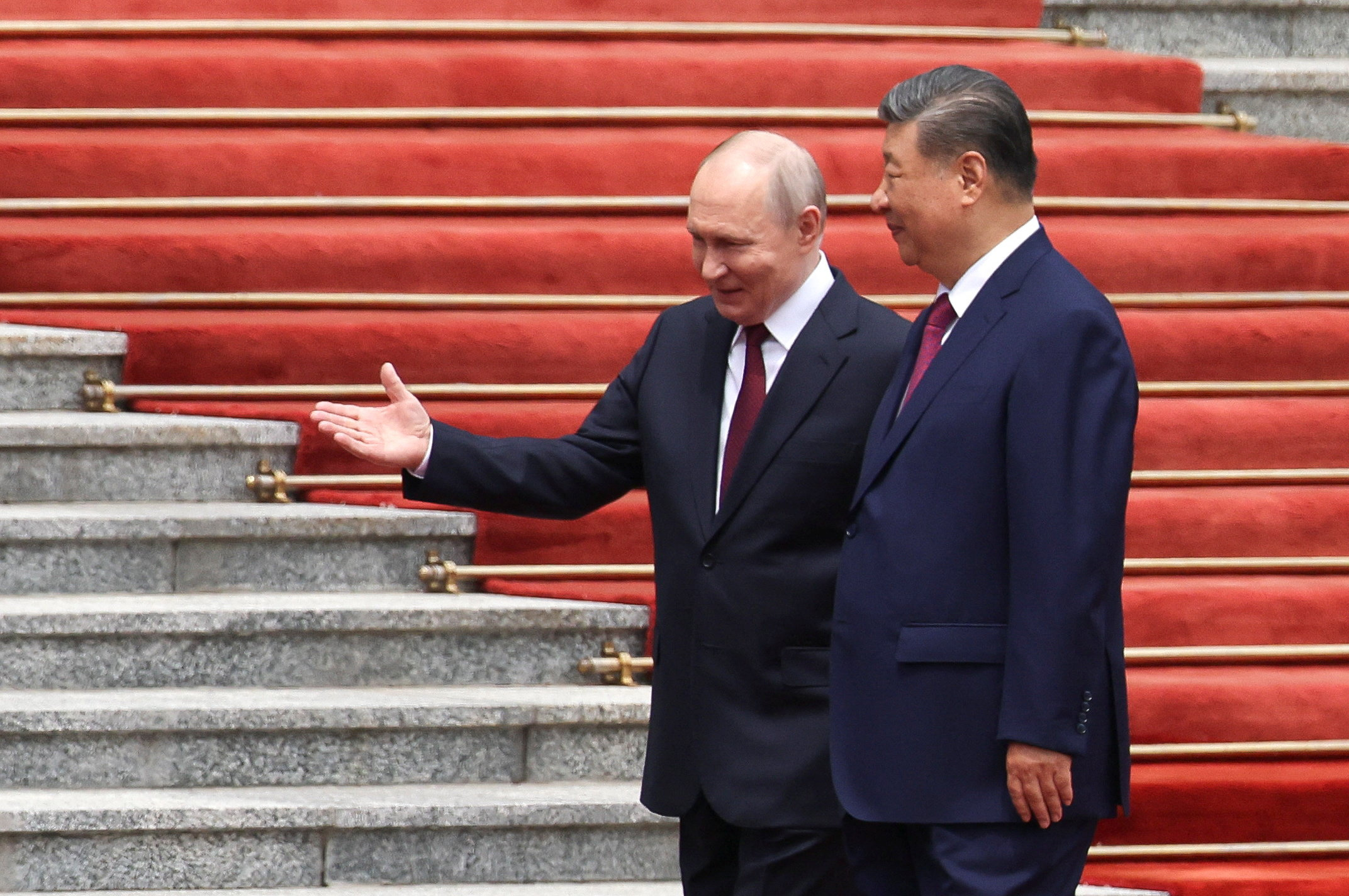 Russian President Vladimir Putin walks with Chinese President Xi Jinping during a welcoming ceremony at the Great Hall of the People in Beijing, China May 20, 2026. REUTERS/Maxim Shemetov/Pool TPX IMAGES OF THE DAY