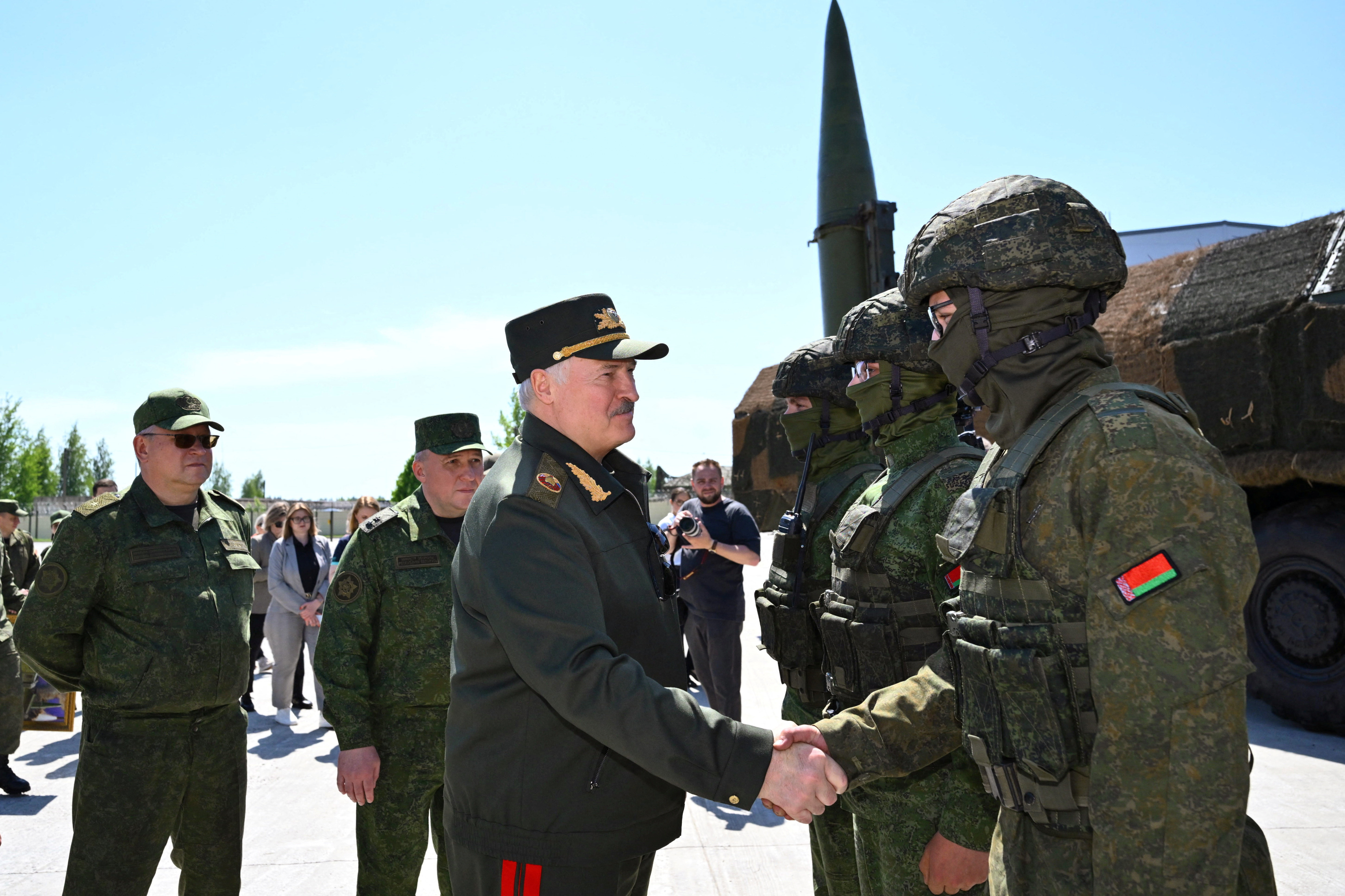 Belarusian President Alexander Lukashenko shakes hands with a service member next to the Iskander-M missile launcher as he visits a missile brigade of the Armed Forces during joint Russian-Belarusian nuclear exercises, in the Asipovichy district, Mogilev region, Belarus, May 21, 2026. President of the Republic of Belarus/Handout via REUTERS ATTENTION EDITORS - THIS IMAGE WAS PROVIDED BY A THIRD PARTY. MANDATORY CREDIT.