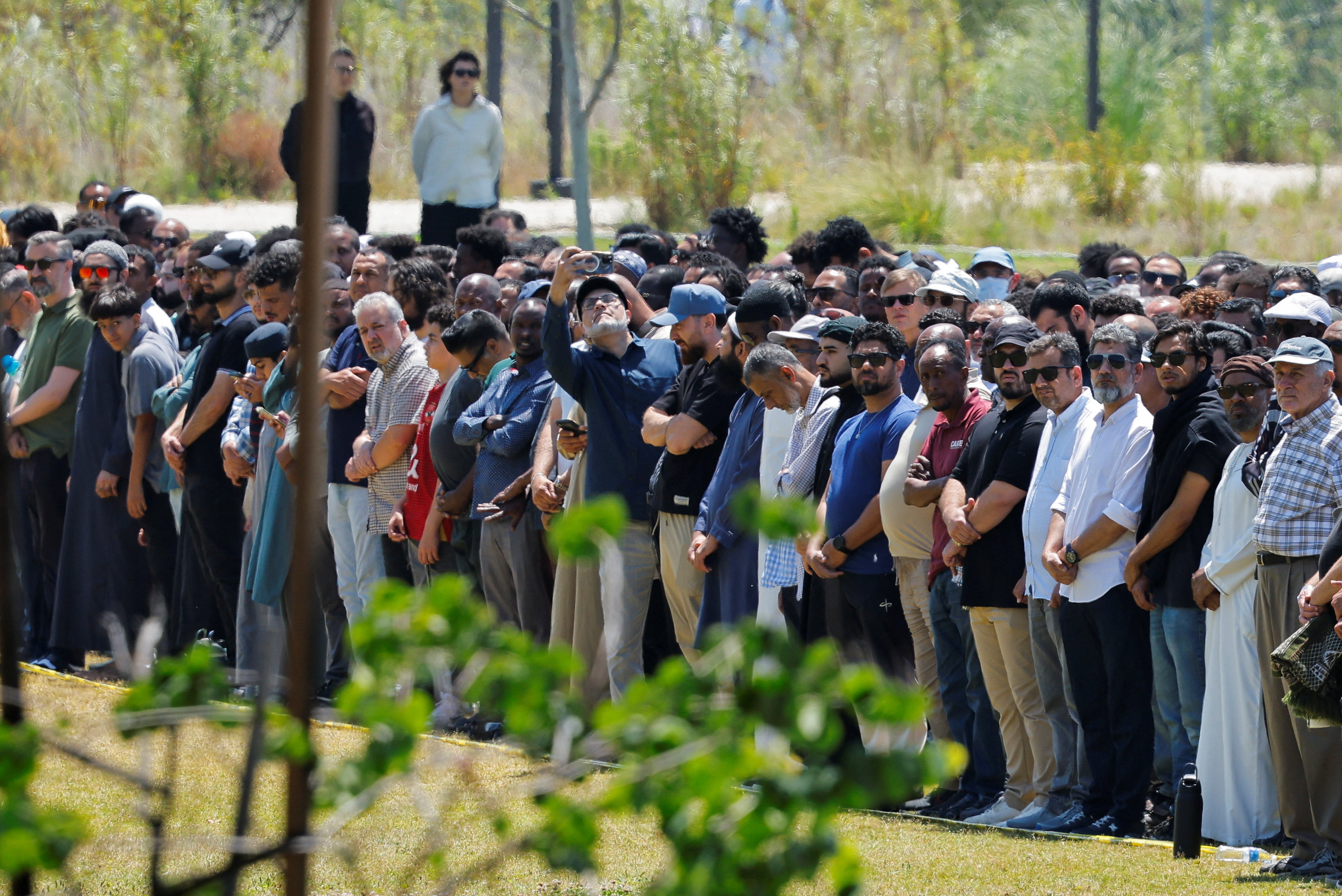 People attend a prayer service for the victims of a shooting at the Islamic Center