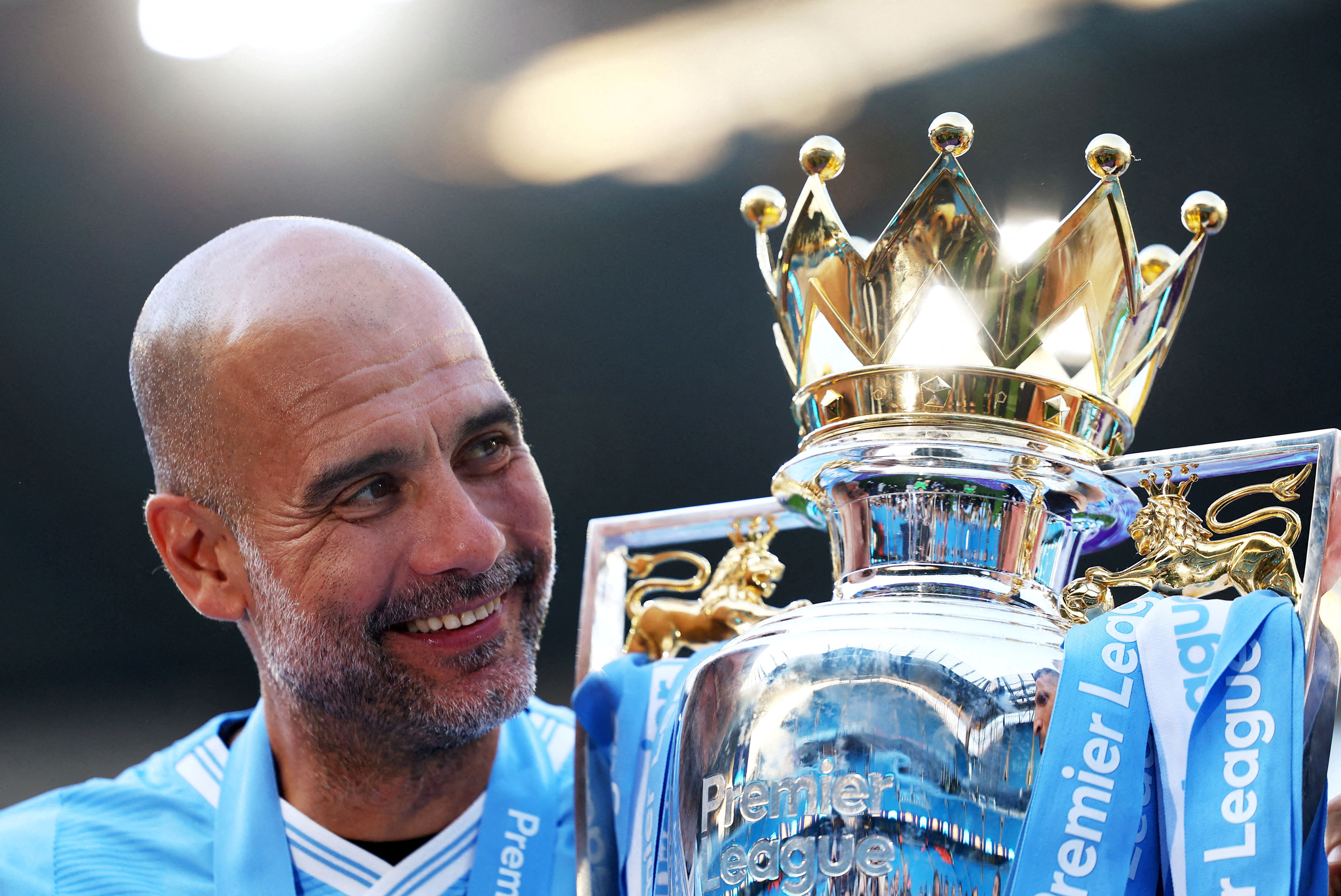 Manchester City manager Pep Guardiola celebrates with the trophy after winning the Premier League in 2024