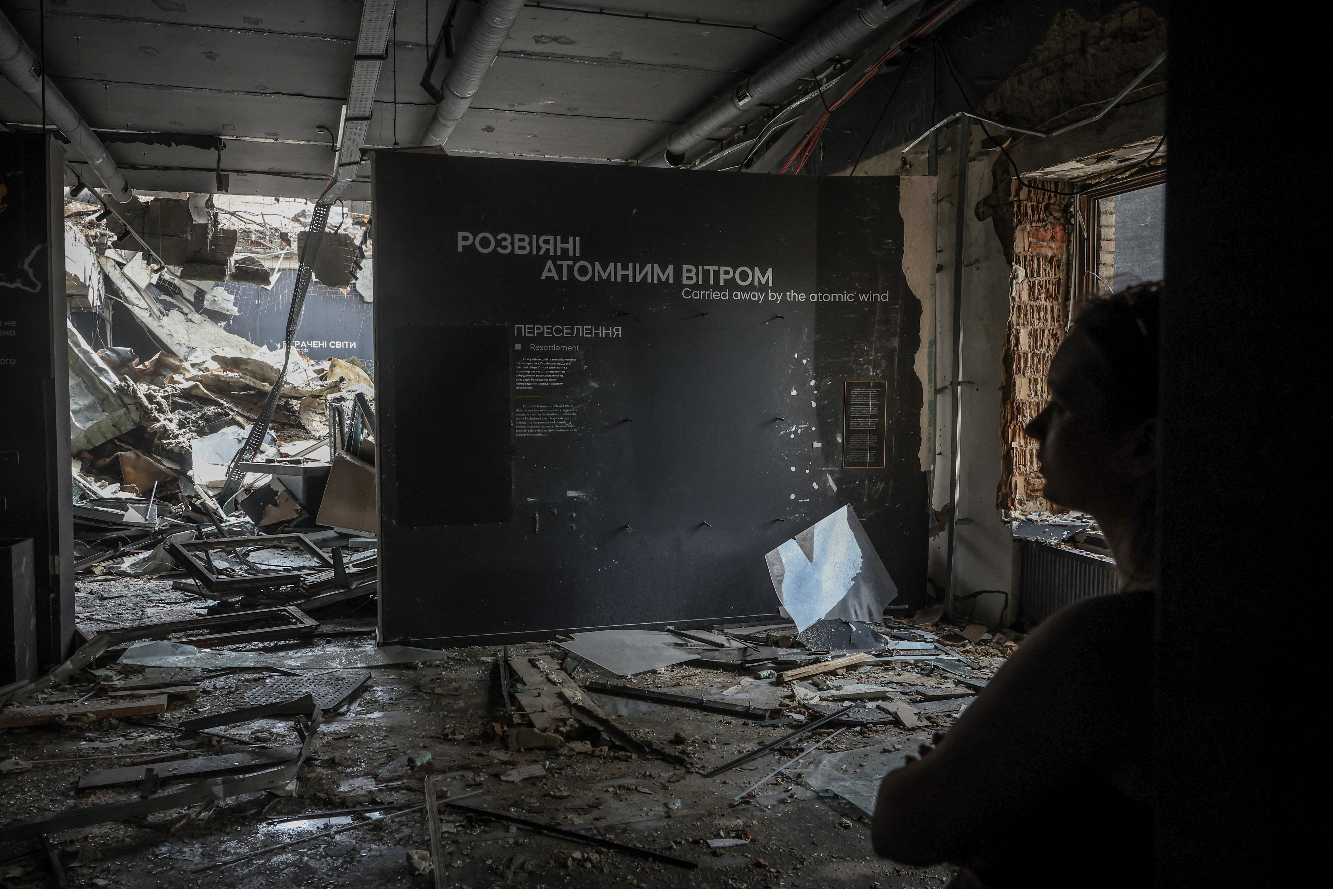A woman appears inside of the building of the Ukrainian National Chernobyl Museum, which was damaged during yesterday’s Russian missile and drone attack, amid Russia's attack on Ukraine, in Kyiv, Ukraine, May 25, 2026. REUTERS/Alina Smutko