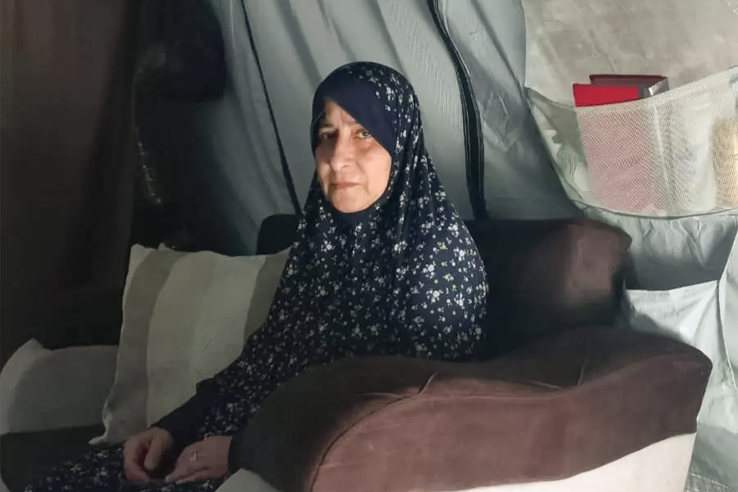 Hanan al-Hams, 65, sits in a makeshift tent pitched over the ruins of her home in northern Gaza. She was selected to perform Hajj in 2024 before the Israeli war shattered her lifelong dream [Al Jazeera]