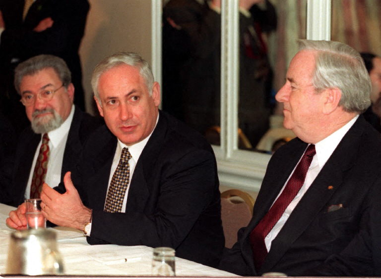 Israeli Prime Minister Benjamin Netanjahu (C) gives a speech to the Christian conservative group Voices United for Israel as Rev. Jerry Falwell (R) and Eliahu Ben Elissar, Israeli ambassador to the US (L), look on, in Washington DC, 19 January. Netanyahu called on the Palestinian Liberation Organization (PLO) to drop part of its charter calling for Israel's destruction. Netanyahu is to meet with US President Bill Clinton at the White House 20 January. AFP PHOTO William PHILPOTT (Photo by WILLIAM PHILPOTT / AFP)