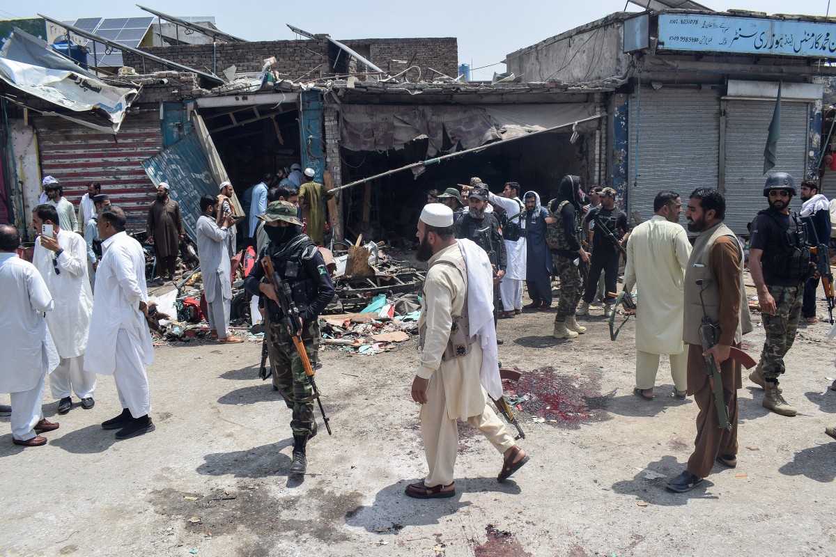 Security personnel inspect the blast site after a suicide attack in the Sarai Naurang area of Pakistans Lakki Marwat district on May 12, 2026. A suicide bomber in a three-wheel vehicle laden with explosives killed at least seven people and wounded 20 in northwest Pakistan, police said on May 12. (Photo by Marwat AKBAR / AFP)