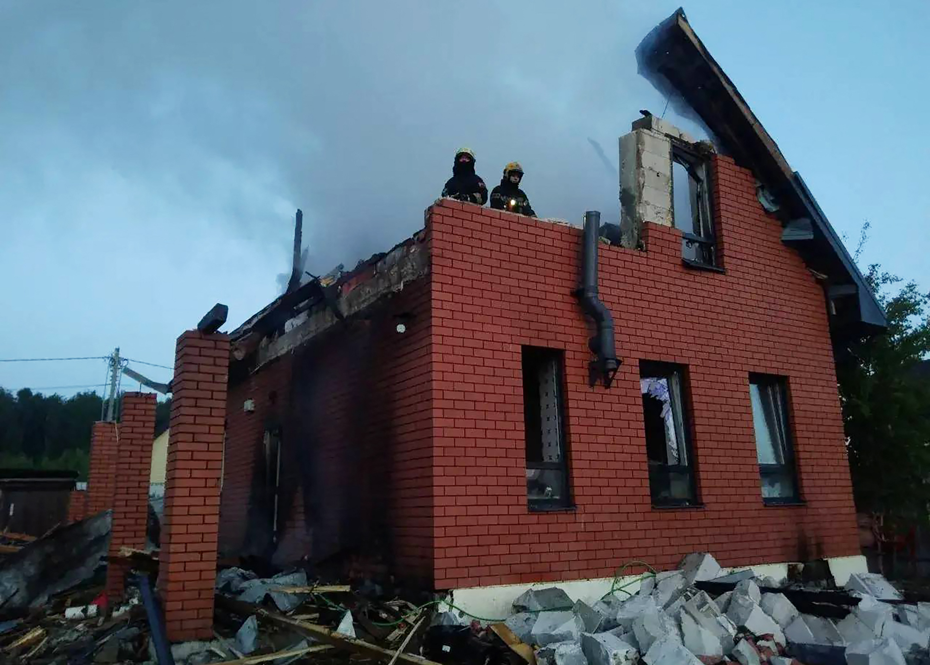 Russian rescuers work in a heavily damaged house