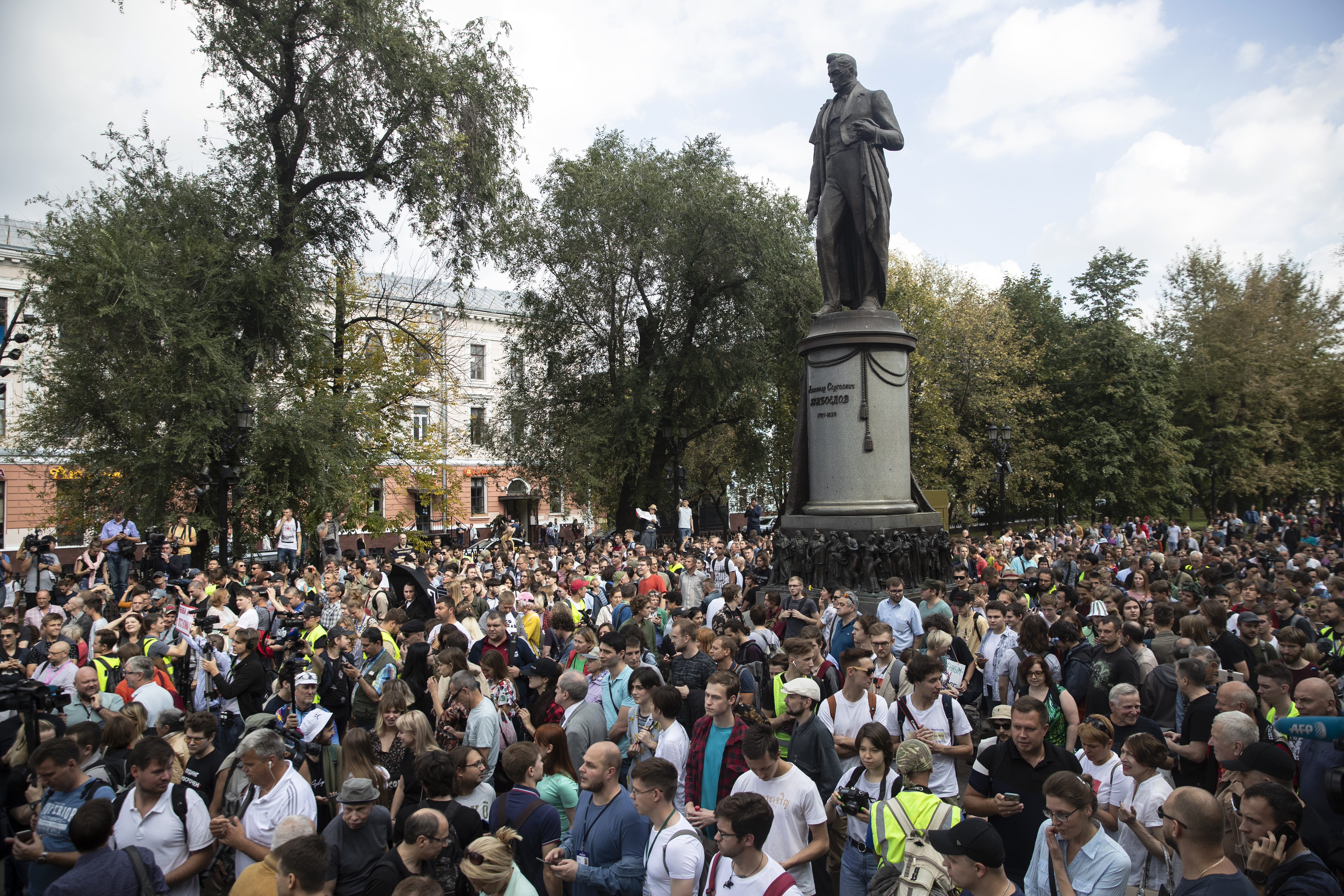 People attend a protest march in Moscow, Russia, the statue of famous Russian poet Alexander Griboyedov in the background on Aug. 31, 2019 [Pavel Golovkin/AP]