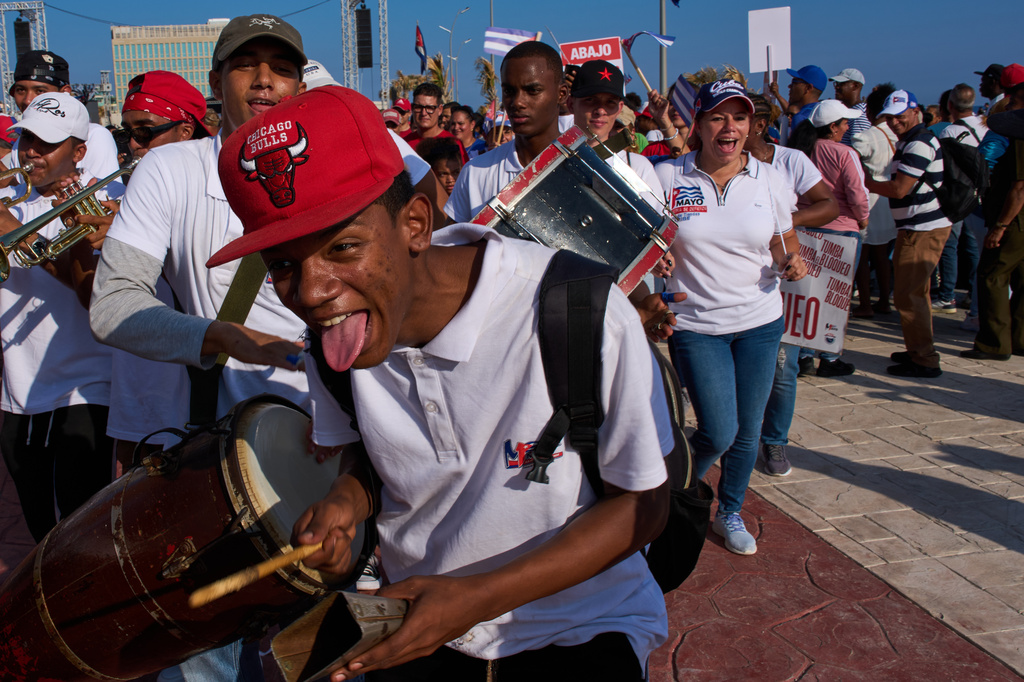 People dance at a march in Havana, Cuba