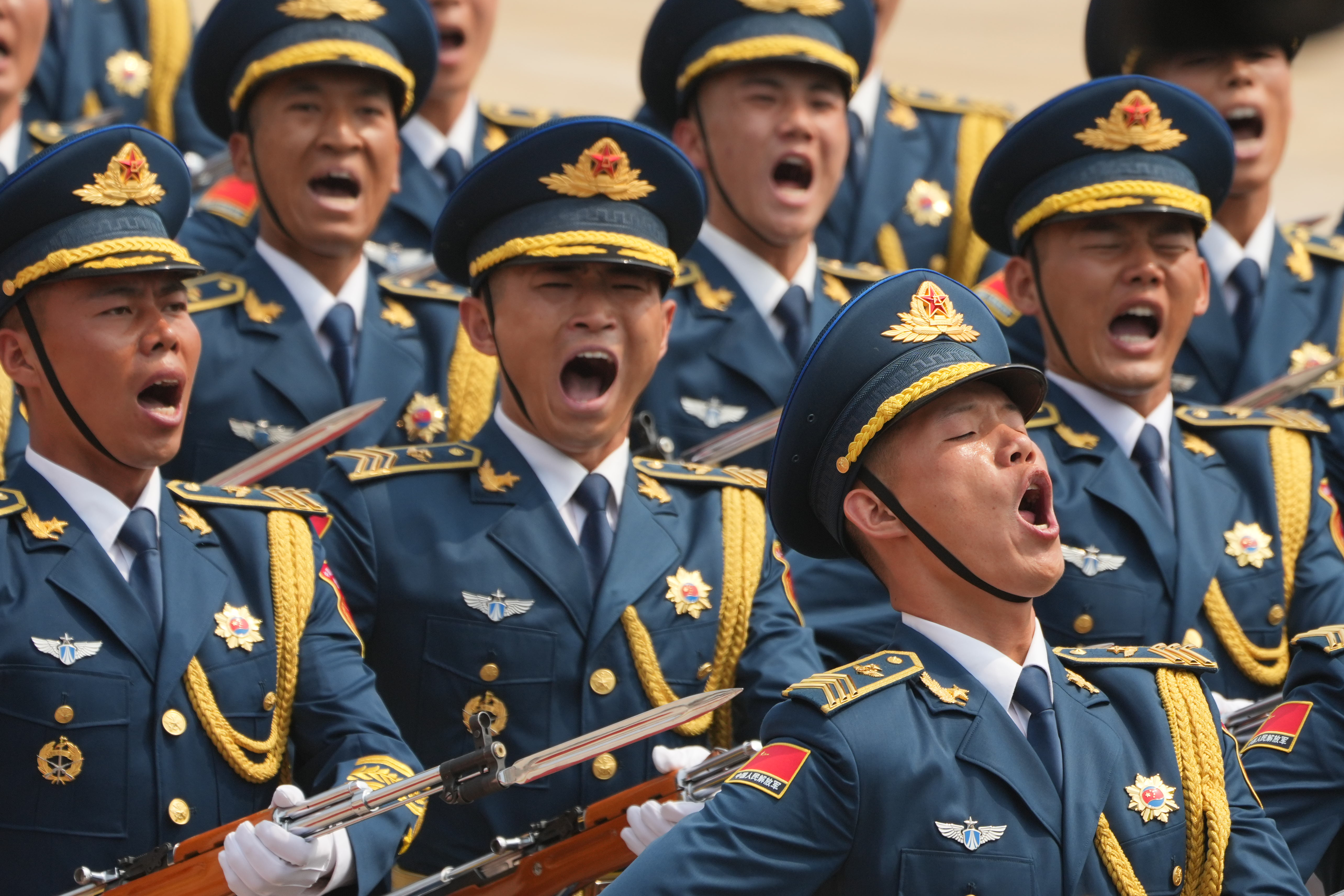 Military members yell as President Donald Trump participates in a welcome ceremony with China's President Xi Jinping at the Great Hall of the People, Thursday, May 14, 2026, in Beijing. (AP Photo/Mark Schiefelbein)
