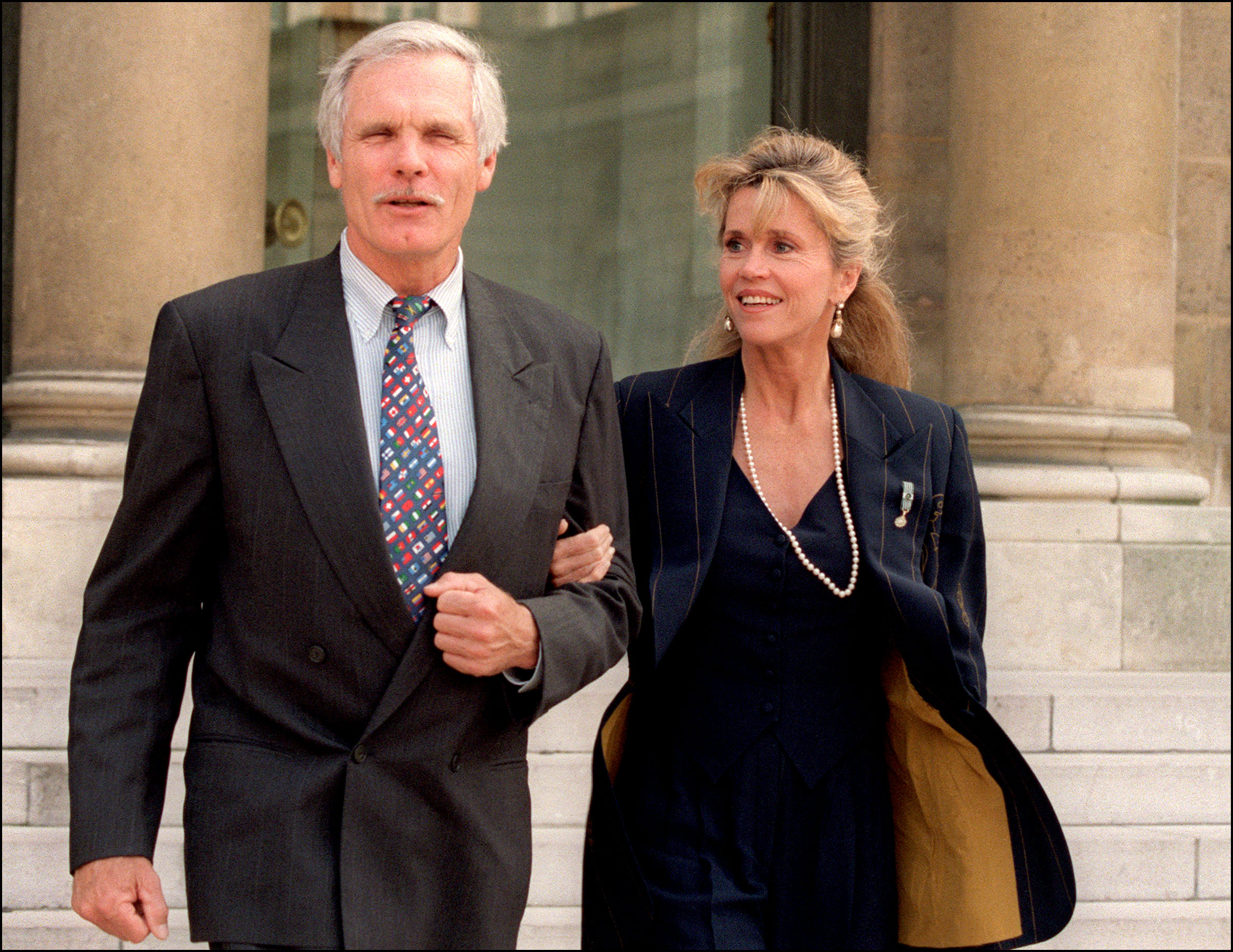 (FILES) Media mogul Ted Turner and his wife, actress Jane Fonda, leave the Elysee Palace on May 18, 1994 in Paris after visiting the French President François Mitterrand.