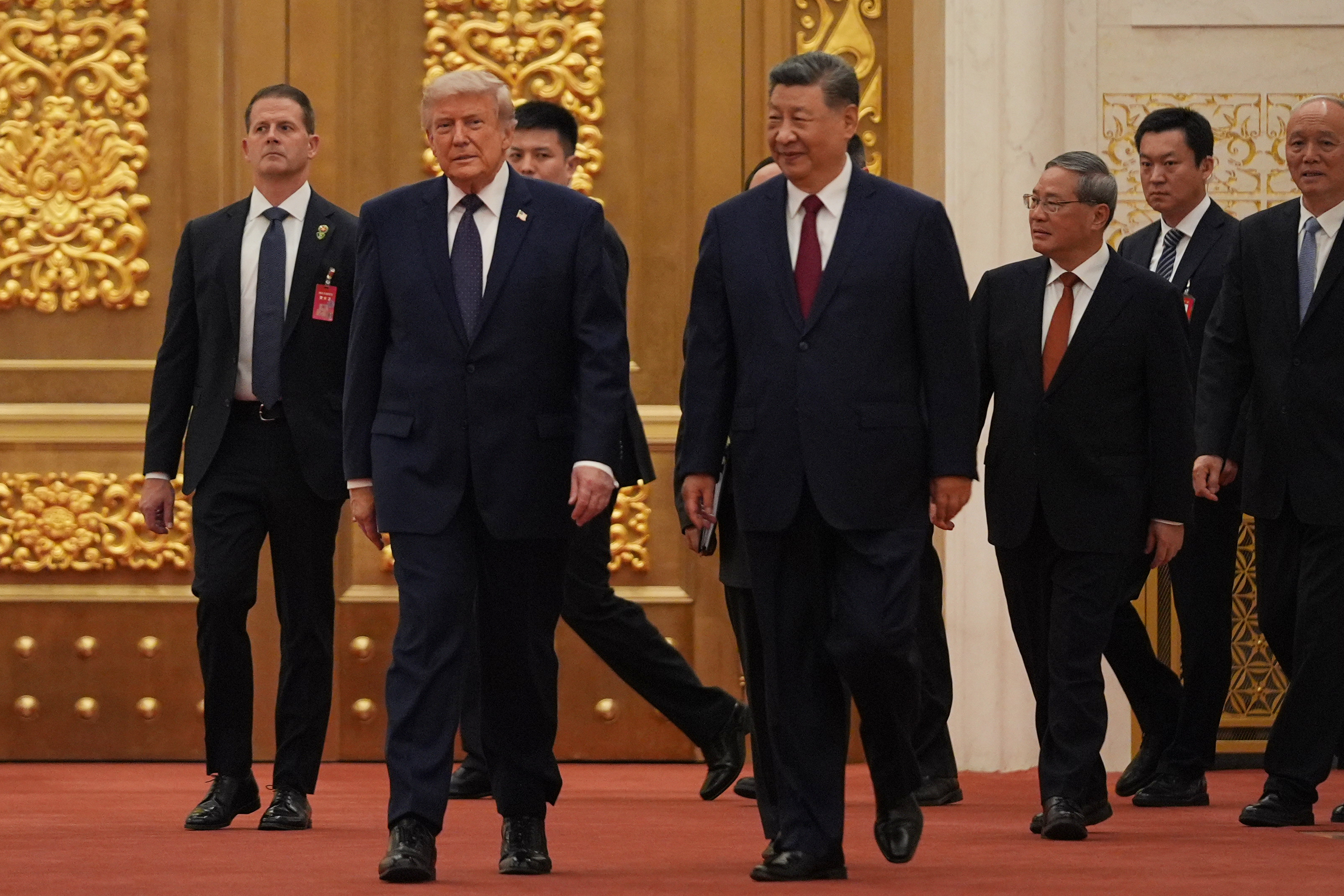 President Donald Trump, second from left, and Chinese President Xi Jinping, fourth from right, arrive for a state dinner at the Great Hall of the People on Thursday May 14, 2026, in Beijing. (AP Photo/Mark Schiefelbein)