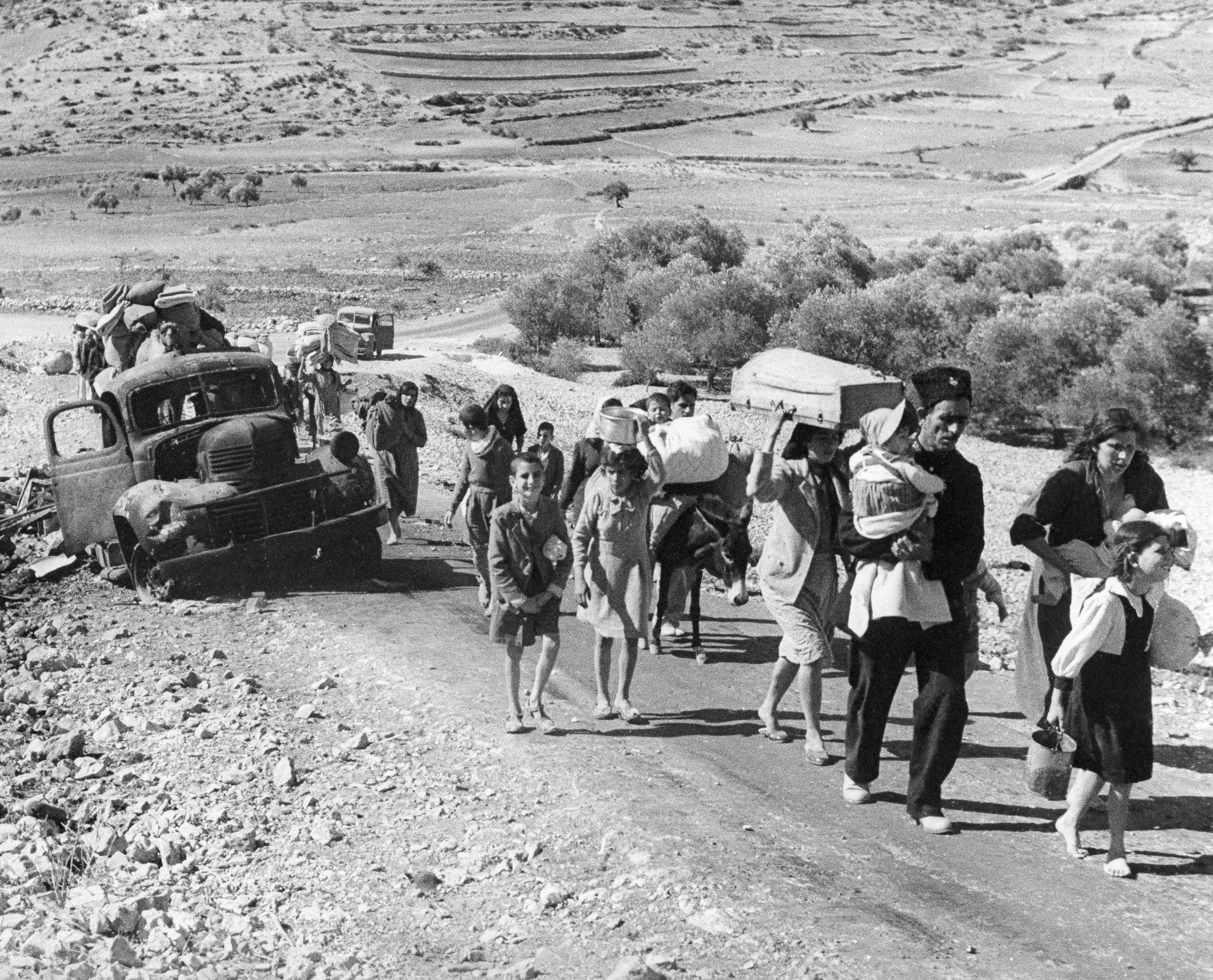 FILE - Palestinian villagers who fled from their homes during fighting between Israeli and Arab troops, on Nov. 4, 1948. (AP Photo/Jim Pringle, File)