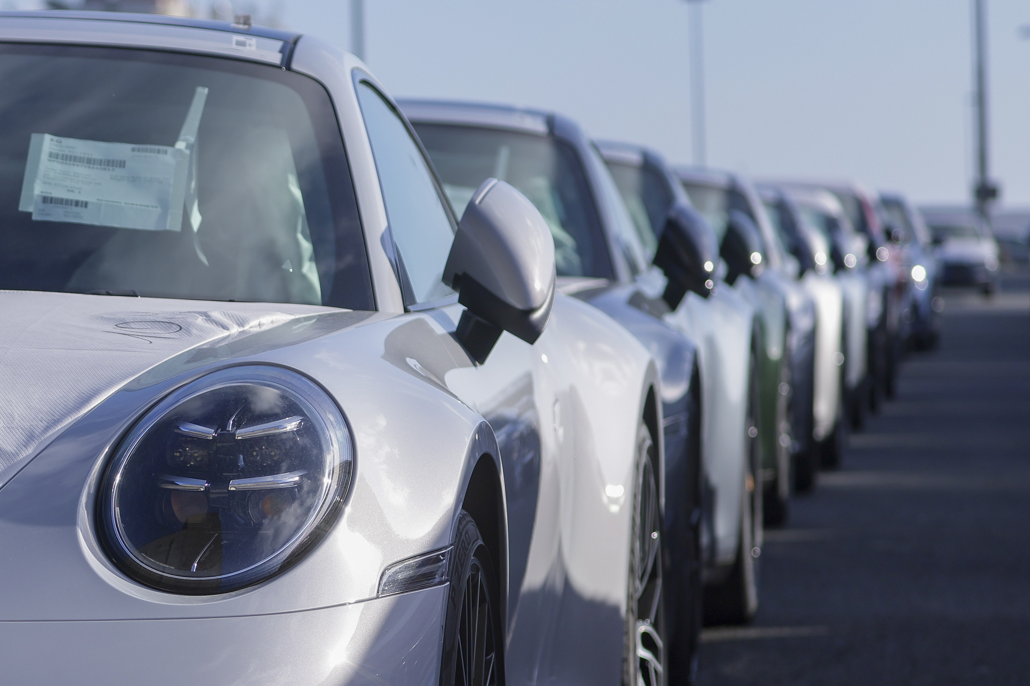 epaselect epa12909841 Cars for export wait for shipment at the port in Emden, Germany, 23 April 2026. Autoport Emden is the third-largest automobile handling port in Europe, with an annual handling volume of around 1.24 million vehicles, mainly brands from the Volkswagen Group including VW, Audi, Porsche, Bentley and Lamborghini. EPA/CHRISTOPHER NEUNDORF
