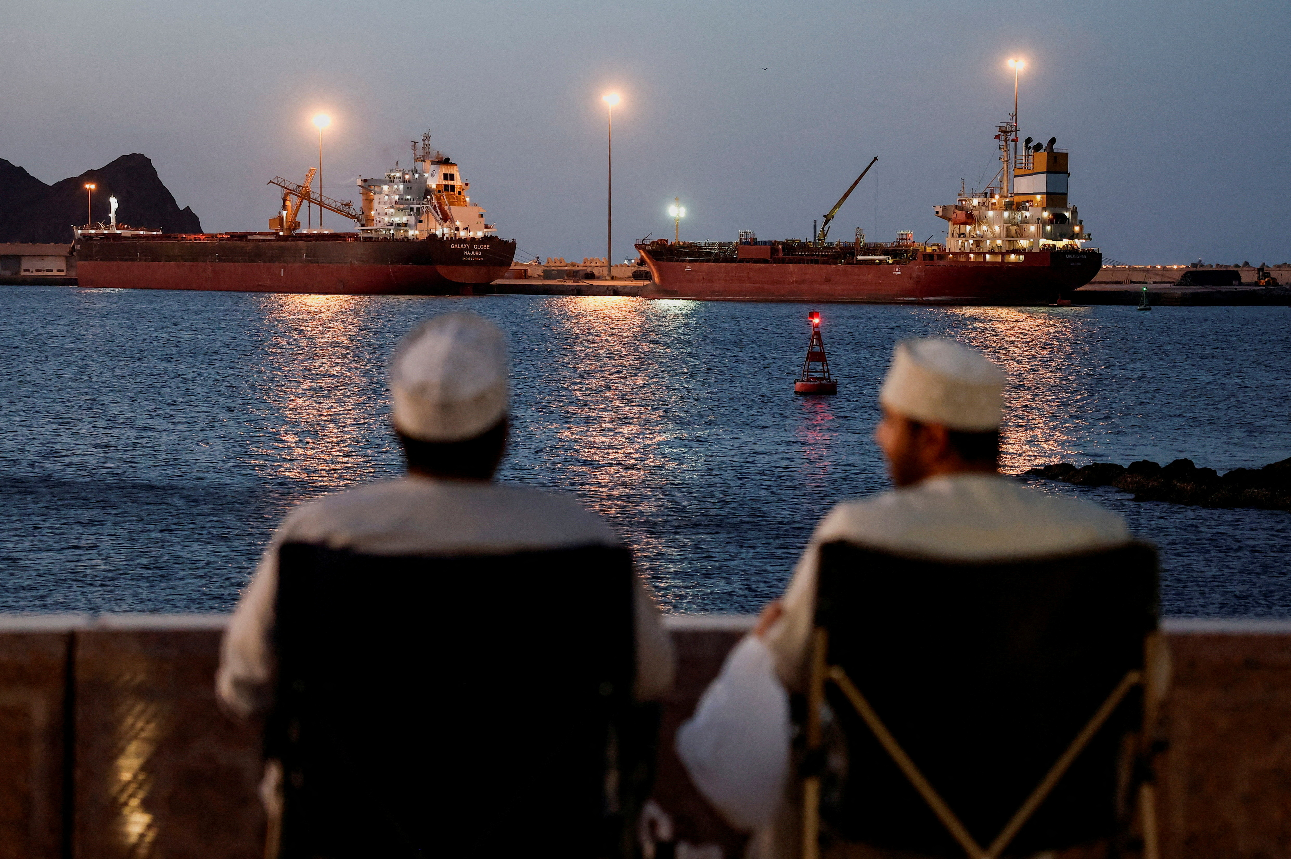 FILE PHOTO: The Galaxy Globe bulk carrier and the Luojiashan tanker sit anchored as Iran vows to close the Strait of Hormuz, amid the U.S.-Israeli conflict with Iran, in Muscat, Oman, March 9, 2026. REUTERS/Benoit Tessier/File Photo