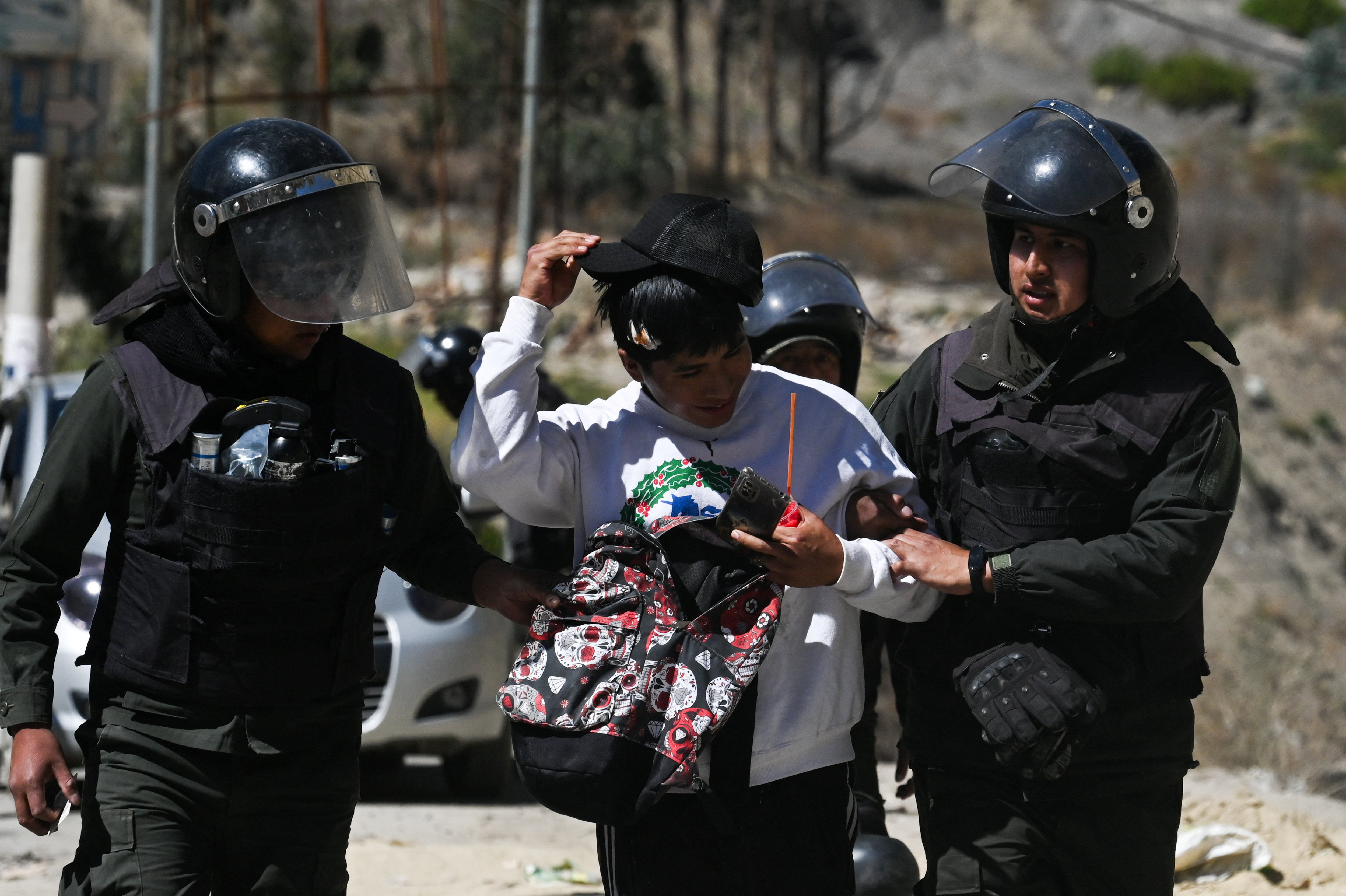 Police officers detain a person during protests against President Rodrigo Paz's government amid an ongoing economic and fuel crisis, in Lipari, Bolivia, May 16, 2026. REUTERS/Claudia Morales