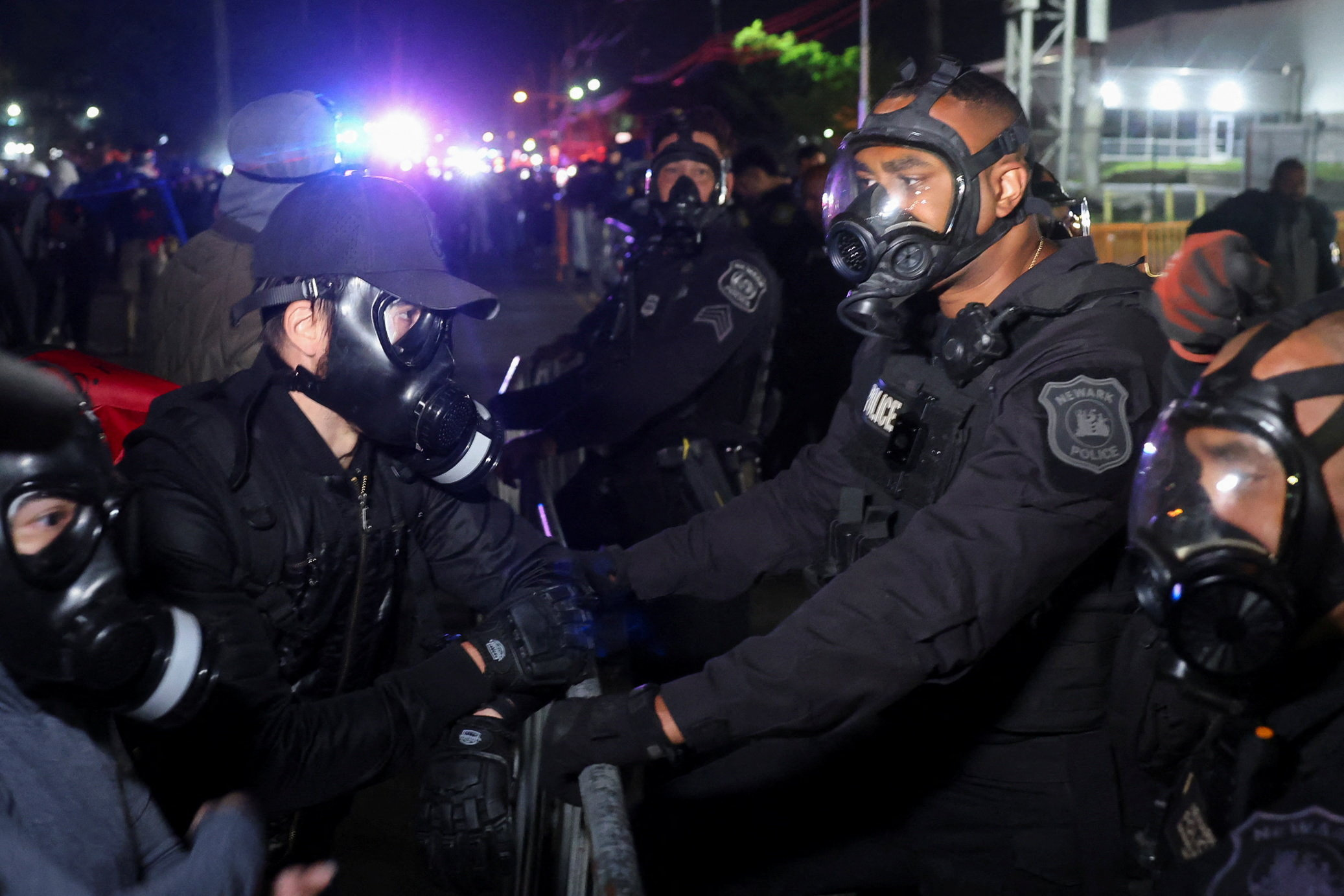 Protesters against U.S. Immigration and Customs Enforcement (ICE) and police officers in gas masks face off outside Delaney Hall detention center, in Newark, New Jersey, U.S., May 30, 2026. REUTERS/Caitlin Ochs