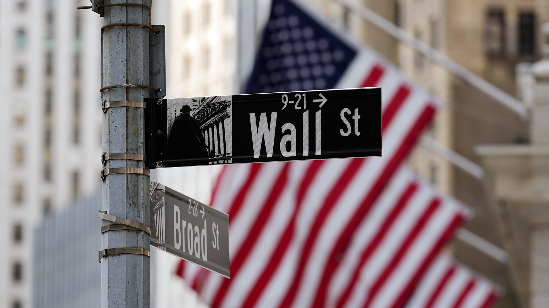 A Wall Street sign is seen outside of the New York Stock Exchange in New York, Monday, March 30, 2026. (AP Photo/Seth Wenig)