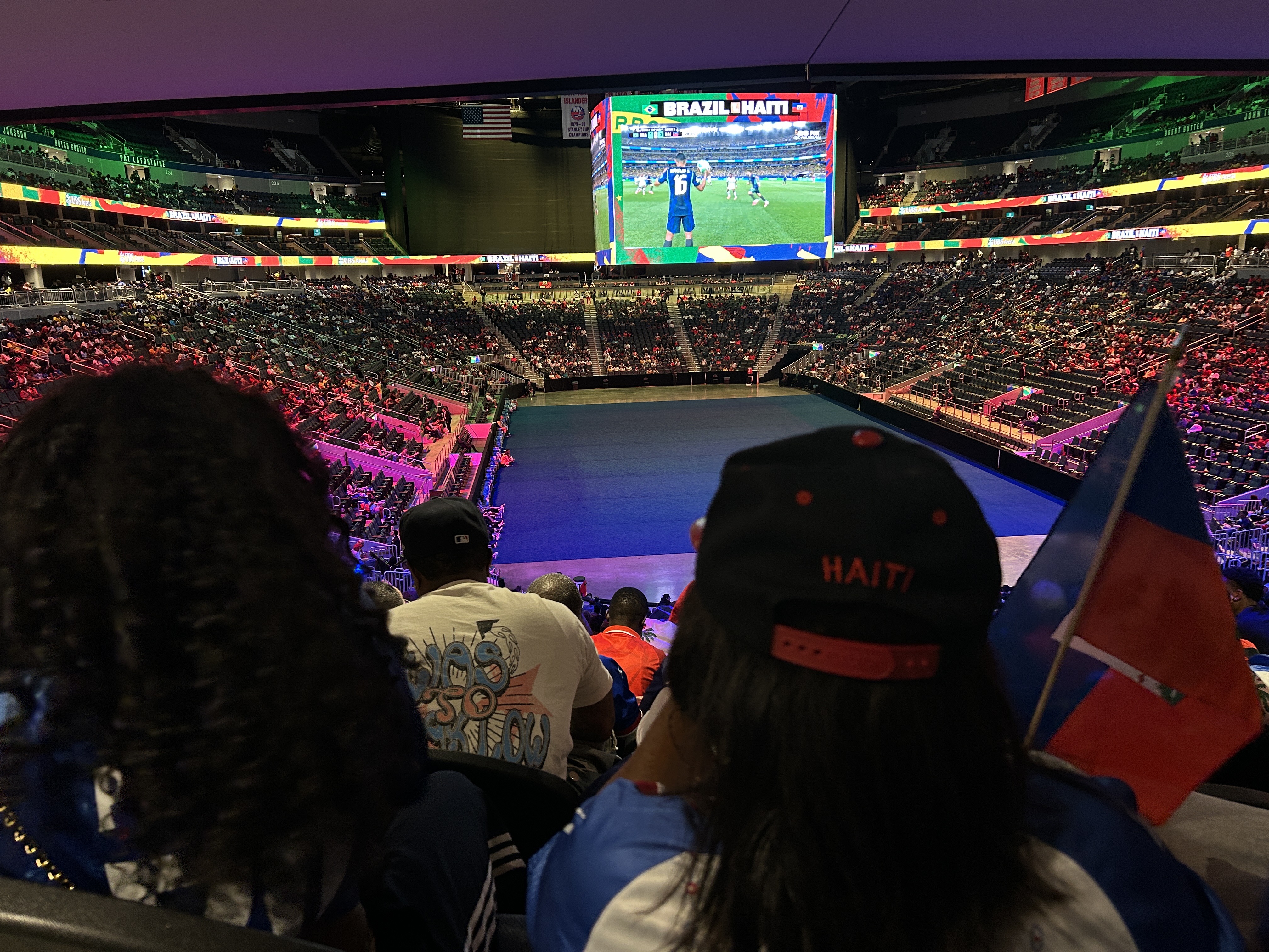 Supporters dressed in red and blue dominate the stands as they stream in for the first few moments of the match [Lauren Ong/Al Jazeera]