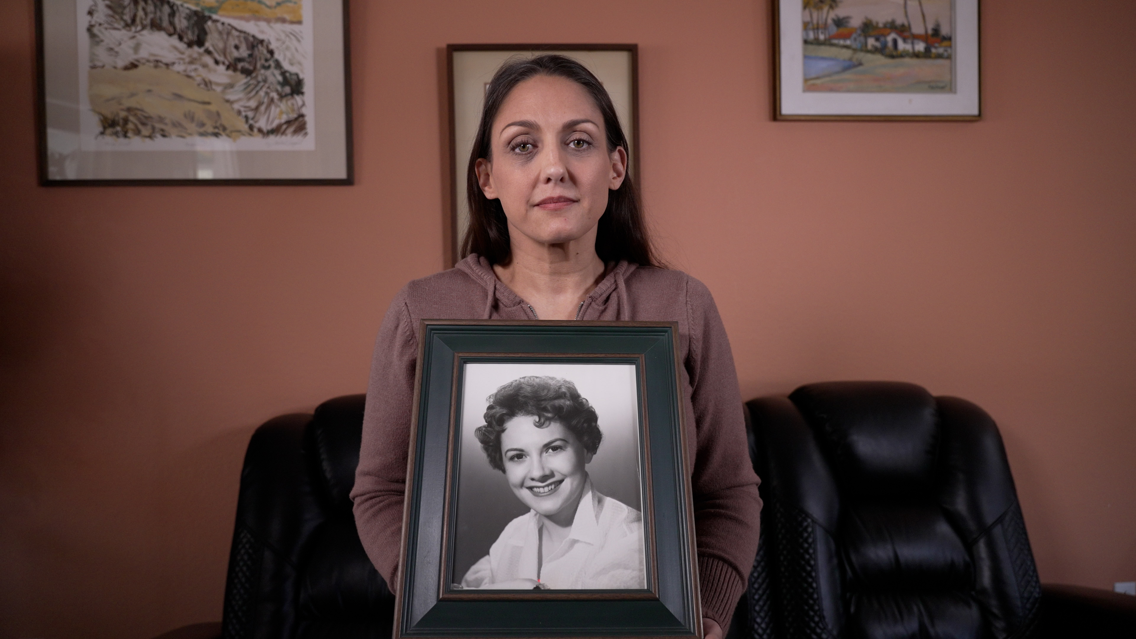 Jennifer Gomez hold a portrait of her grandmother, Jean McNeil Sargent, in San Diego