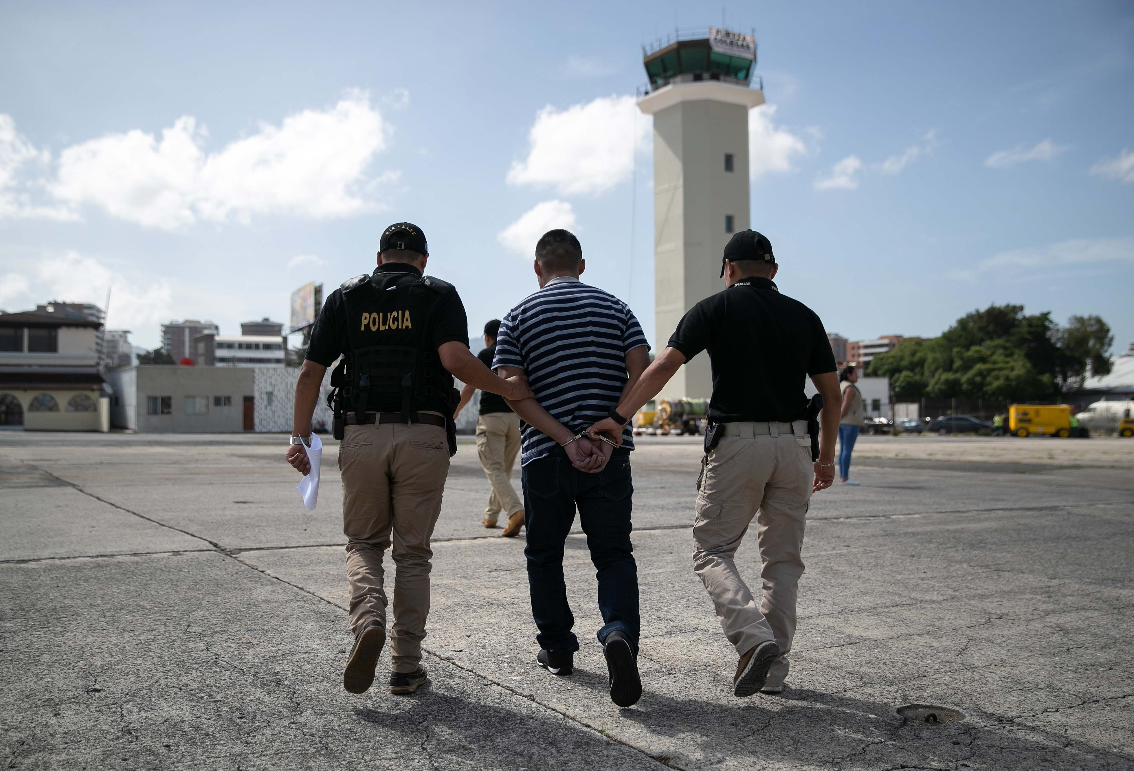 GUATEMALA CITY, GUATEMALA - AUGUST 29: Guatemalan police escort a convicted criminal who arrived on an ICE deportation flight from Brownsville, Texas on August 29, 2019 to Guatemala City. Under a new policy, ICE has expedited removal procedures for many Guatemalan families and adults arriving to the U.S.-Mexico border. (Photo by John Moore/Getty Images)