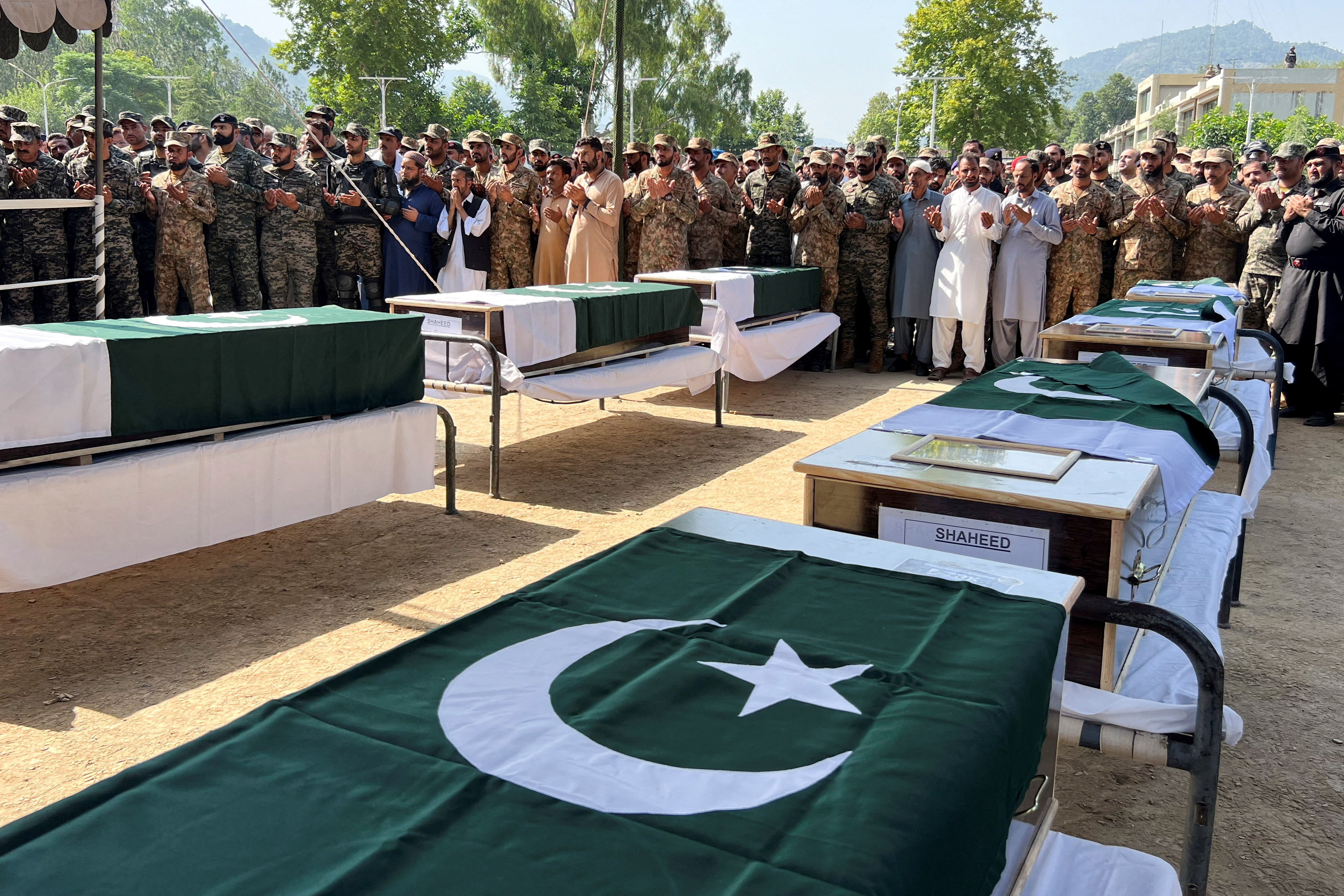 Pakistani Army officers and people offer prayers as they attend the funeral of the victims, who died after an Mi-17 helicopter of Pakistan Army Aviation crashed near Muzaffarabad on Wednesday during take-off, in Muzaffarabad, Pakistani Kashmir, June 11, 2026. Picture taken with a mobile phone. REUTERS/Naseer ud Din TPX IMAGES OF THE DAY