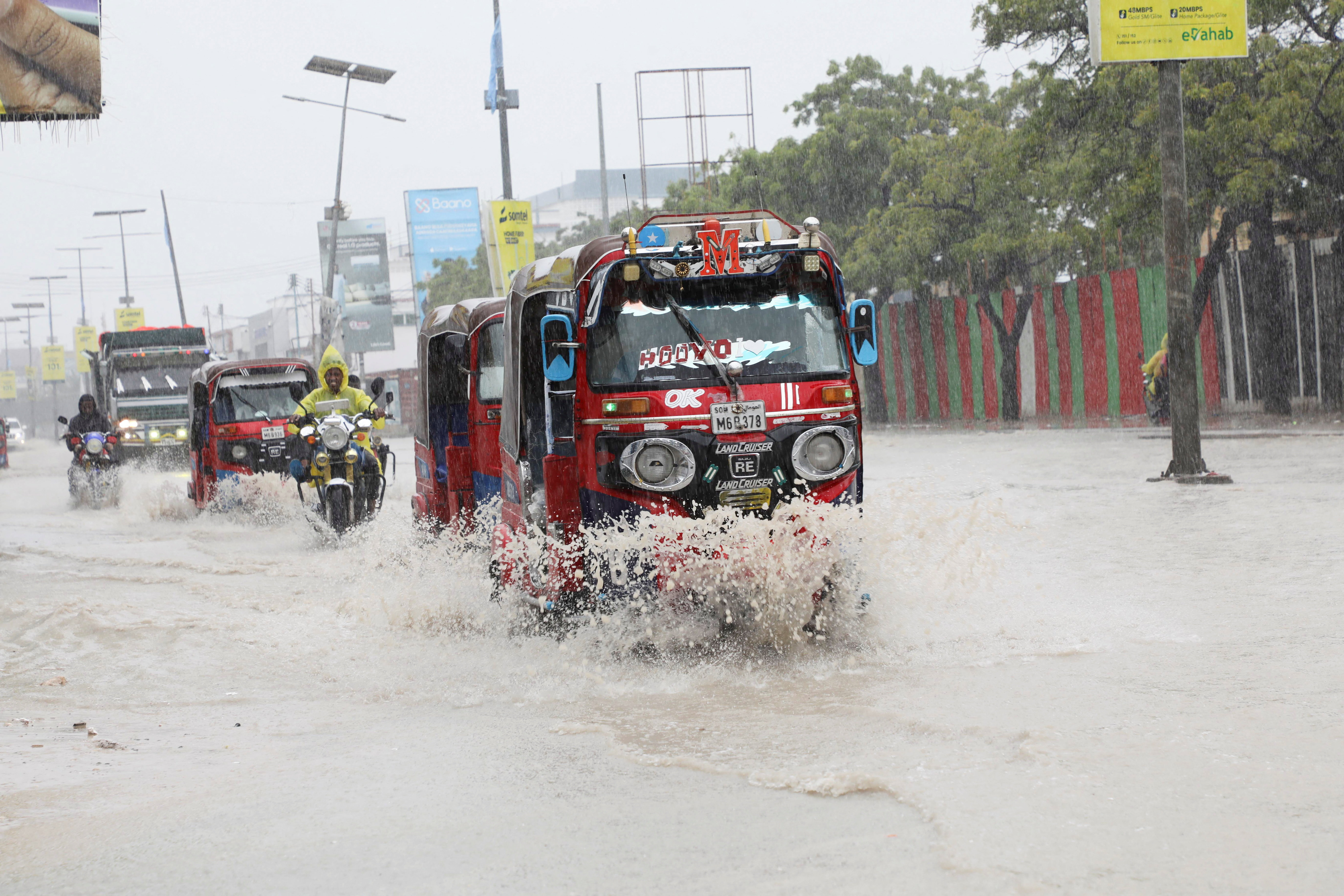 Rickshaw tuktuks drive through floodwater along KM4 street, following a heavy downpour in Mogadishu, Somalia, June 21, 2026. REUTERS/Feisal Omar
