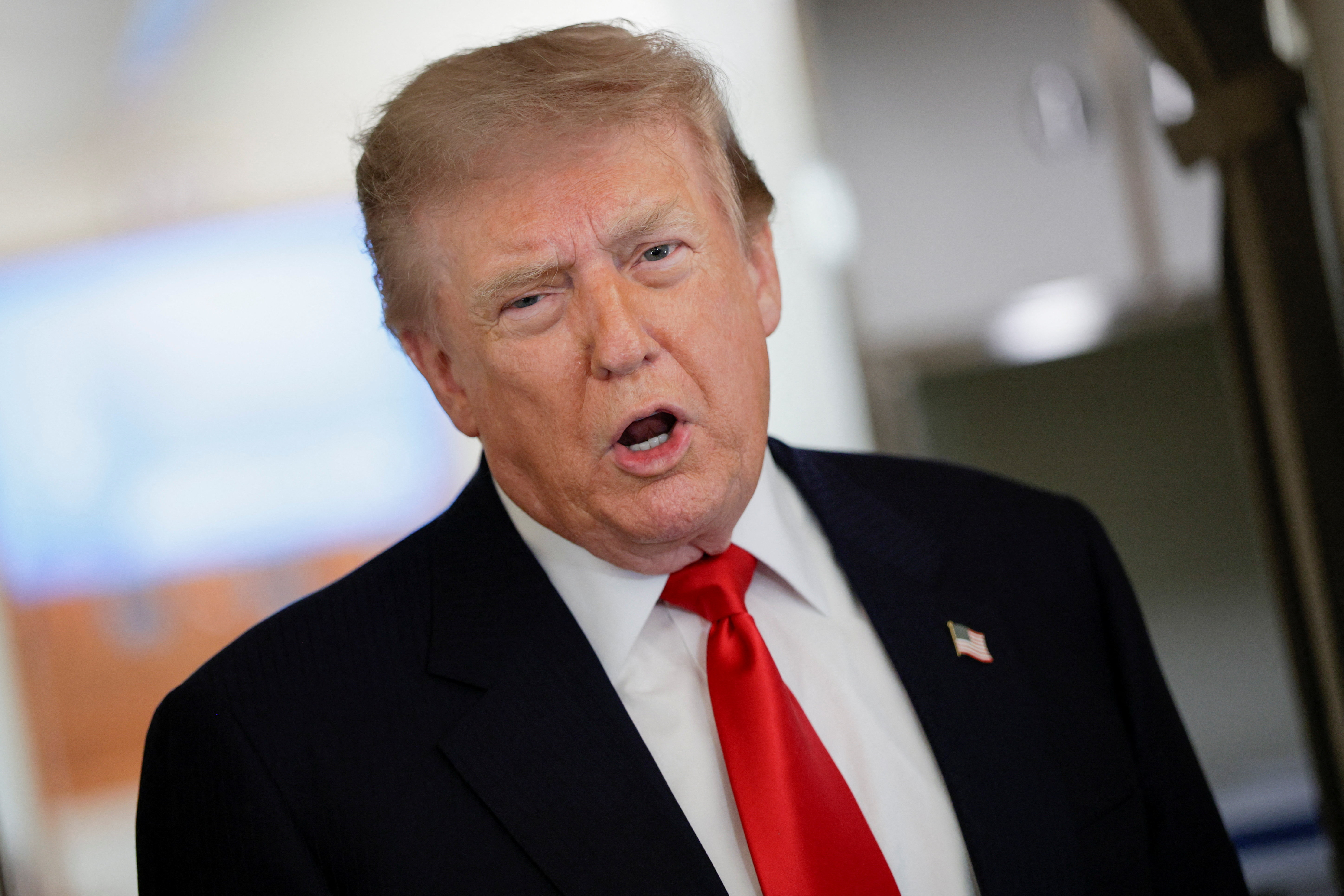 U.S. President Donald Trump speaks to reporters aboard Air Force One en route to Michigan, U.S., July 27, 2026. REUTERS/Evan Vucci