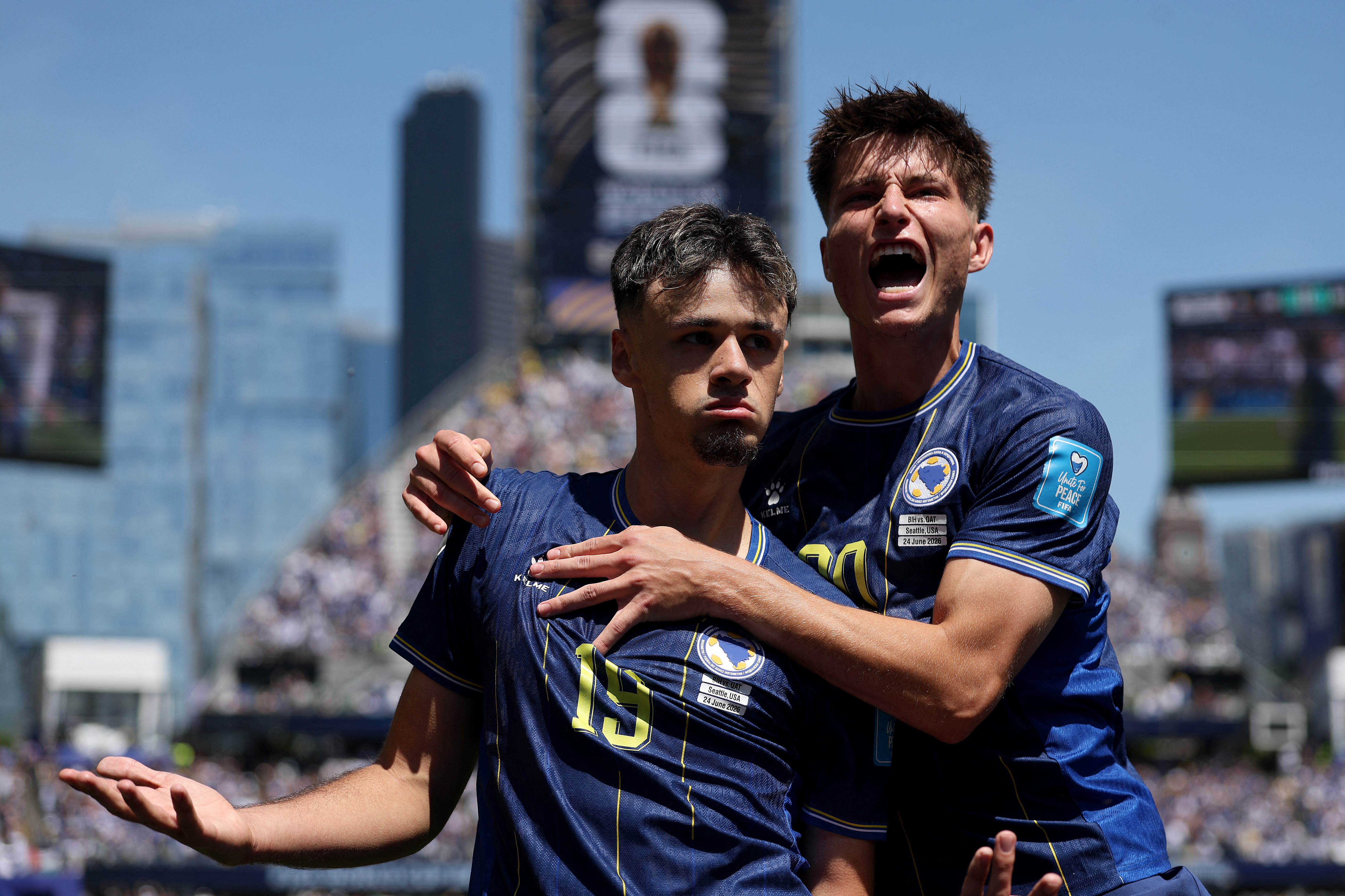 SEATTLE, WASHINGTON - JUNE 24: Kerim Alajbegovic #19 of Bosnia and Herzegovina celebrates with Esmir Bajraktarevic #20 after scoring the team's first goal during the FIFA World Cup 2026 Group B match between Bosnia and Herzegovina and Qatar at Seattle Stadium on June 24, 2026 in Seattle, Washington. Stu Forster/Getty Images/AFP (Photo by Stu Forster / GETTY IMAGES NORTH AMERICA / Getty Images via AFP)