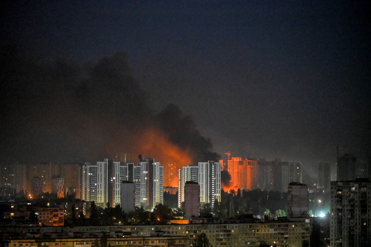 A view of buildings on fire in the night.