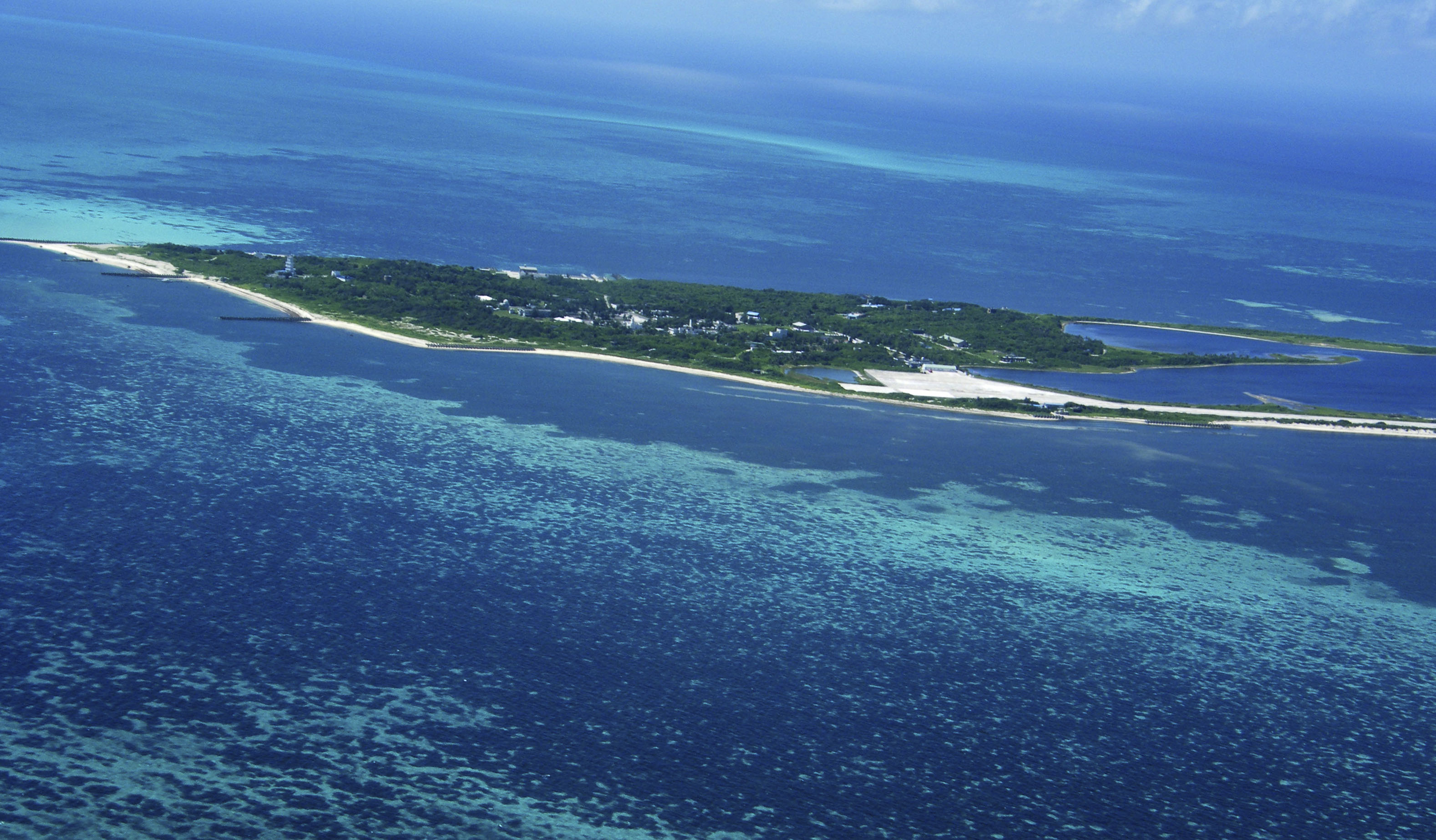 An aerial view of the outlying Atoll National Park of the Dongsha Islands, 150 miles (236 kilometers) southwest of the southern Taiwanese port of Kaohsiung, Taiwan, Wednesday, Sept. 15, 2010. Democratic Taiwan has controlled remote Dongsha Island in the South China Sea since it split from the Chinese mainland 61 years ago, but even with Beijing's rapidly expanding naval power, the communist colossus appears to be making no play to assert claims of sovereignty over the tiny spit of land, 211 miles (340 kilometers) southeast of the Chinese territory of Hong Kong and 150 miles (236 kilometers) southwest of the southern Taiwanese port of Kaohsiung. (AP Photo/Peter Enav)