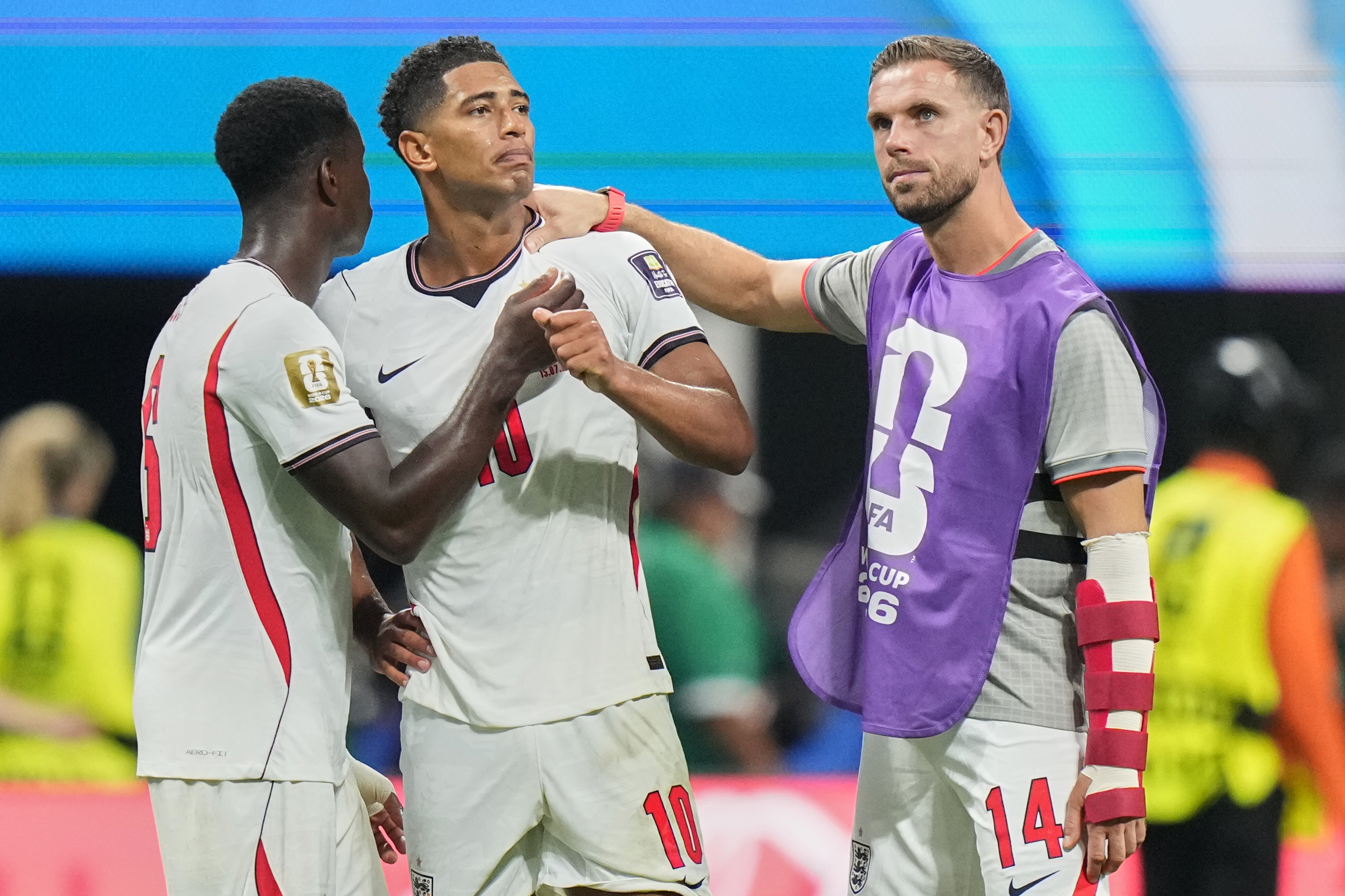 England's Jude Bellingham (10) is consoled by Marc Guehi (6) and Jordan Henderson (14) after the World Cup semifinal soccer match between England and Argentina in Atlanta, Wednesday, July 15, 2026. (AP Photo/Stephanie Scarbrough)