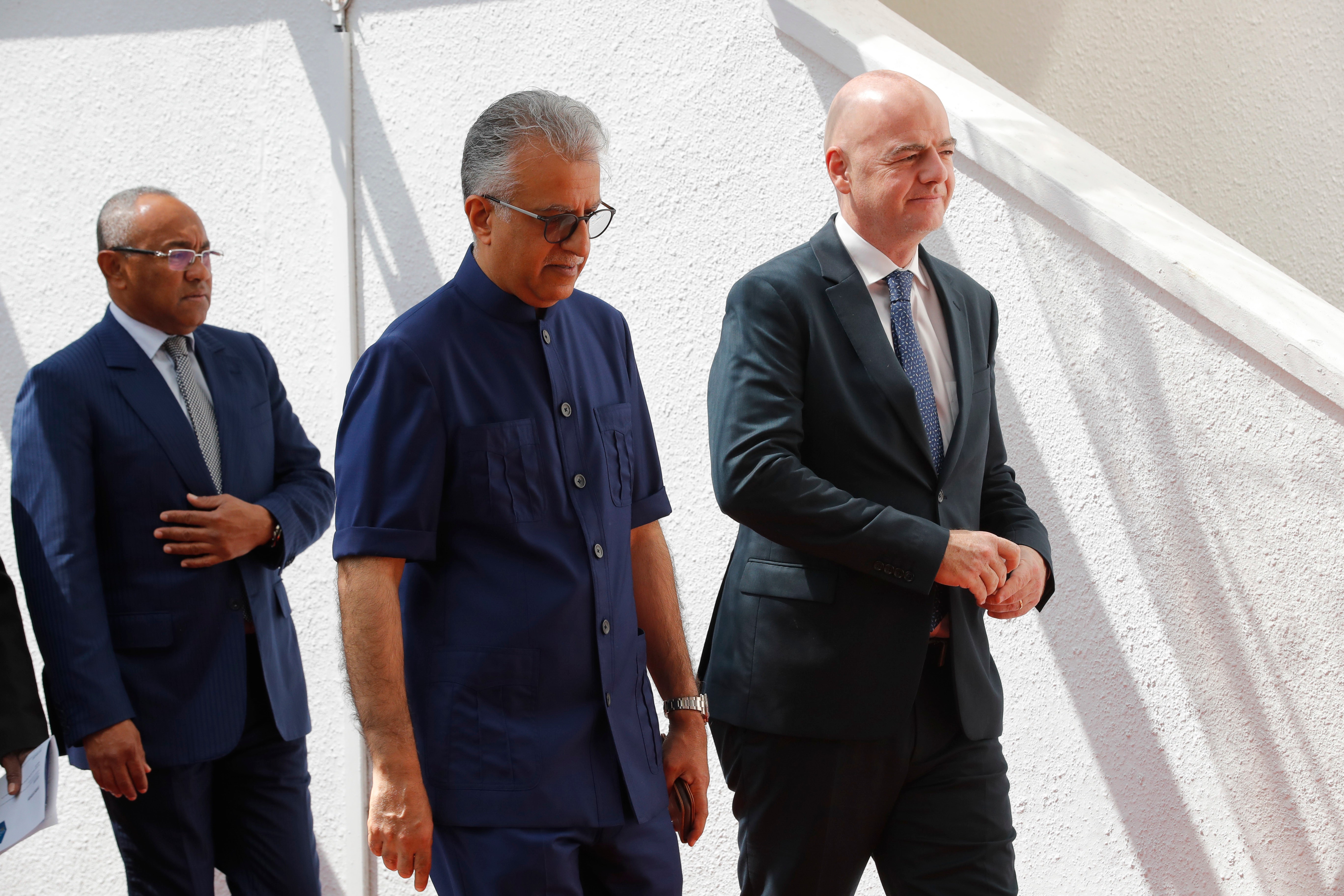 Asia Football Confederation President Salman bin Ebrahim Al Khalifa, centre, walks with FIFA President Gianni Infantino, right.