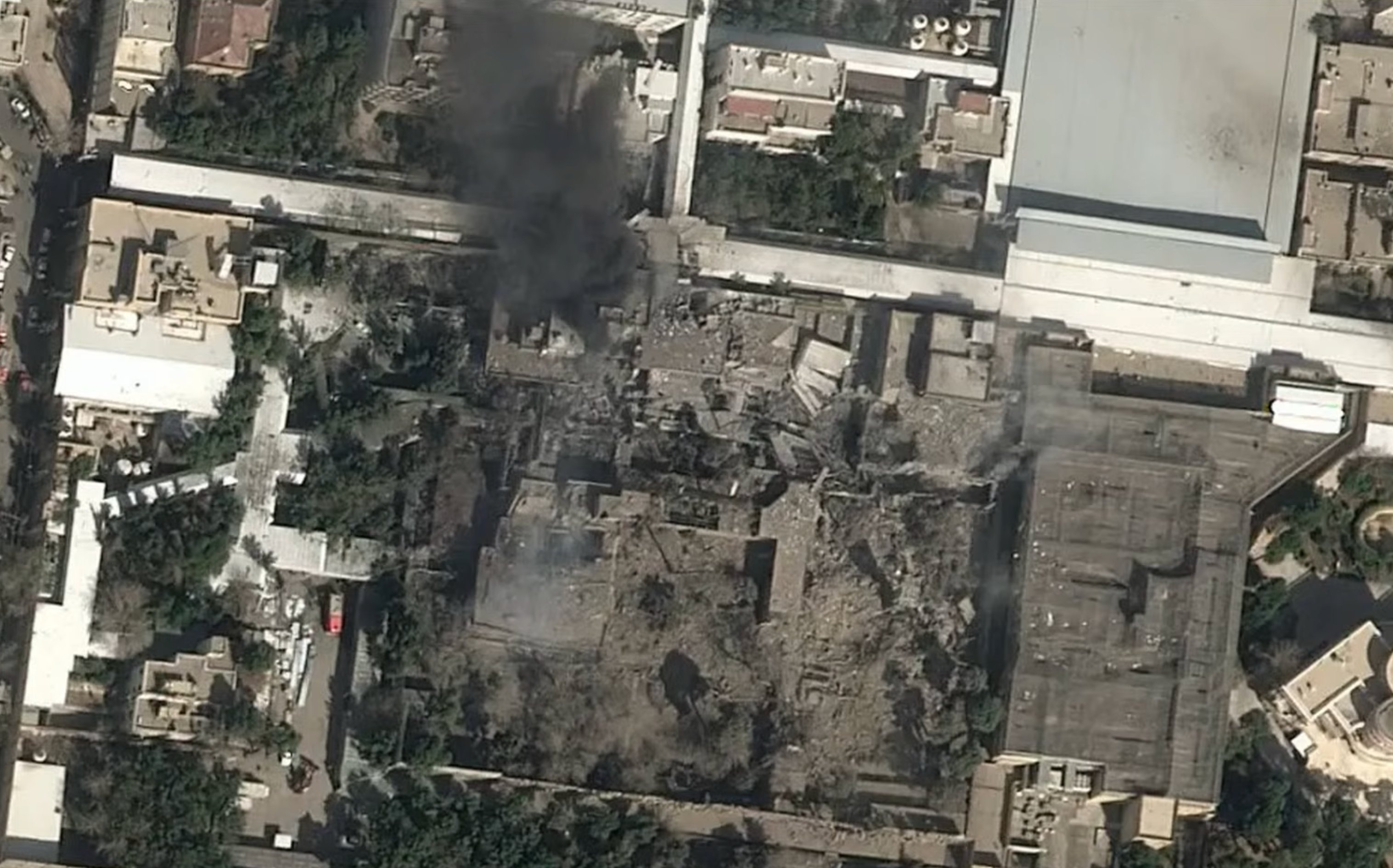 A satellite image shows black smoke rising and heavey damage at the compound of Iran's supreme leader, Ayatollah Ali Khamenei