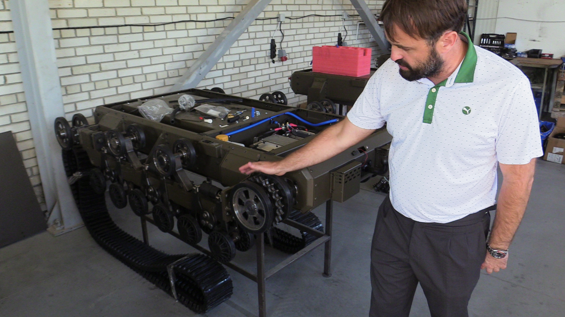 Ihor-Chaikivsky-stands-next-to-a-dismantled-ground-robot-his-company-manufactures