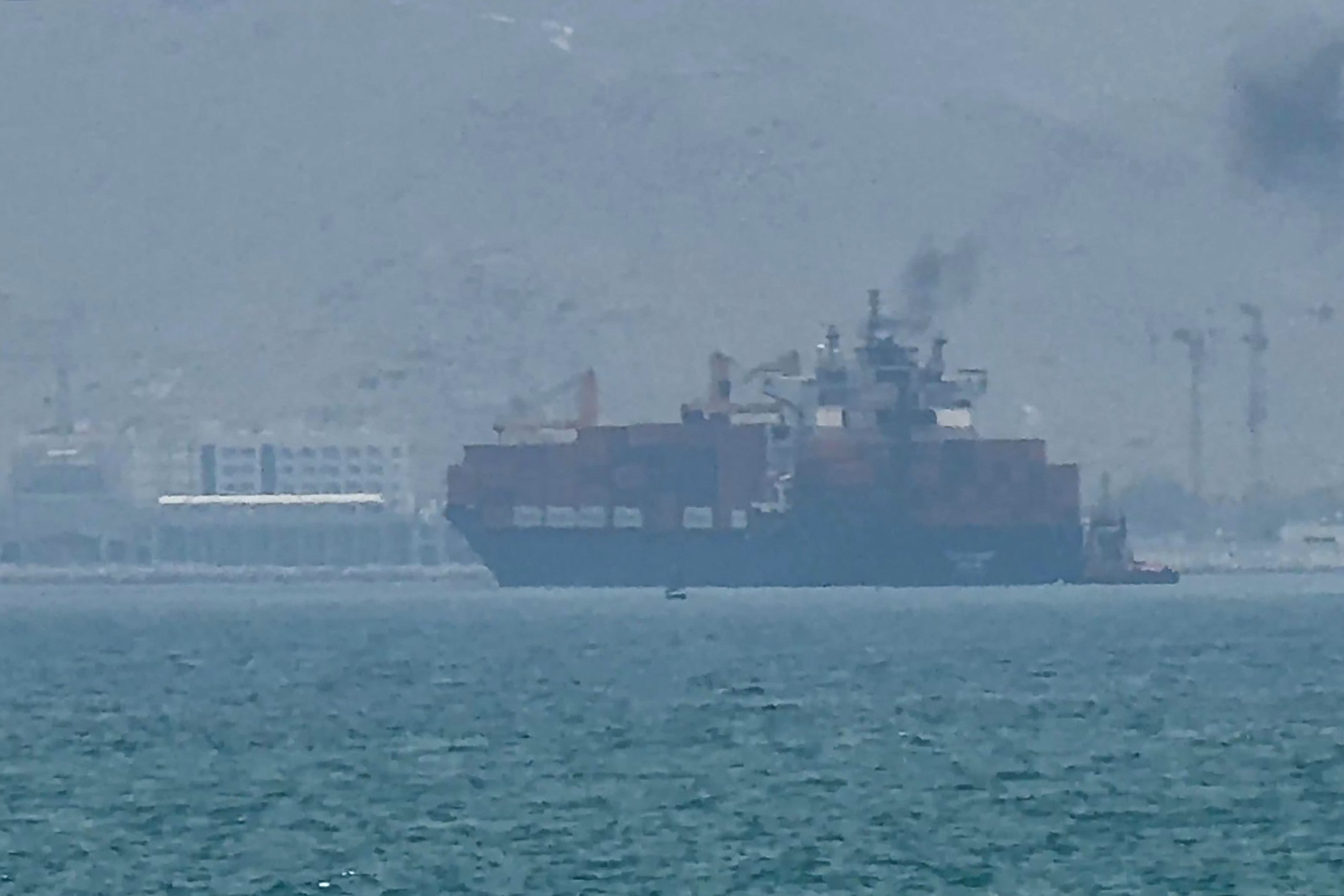 This frame grab taken from AFPTV video footage on July 12, 2026 shows a cargo ship anchoring near the Strait of Hormuz off the eastern coast of the United Arab Emirates at Khor Fakkan.