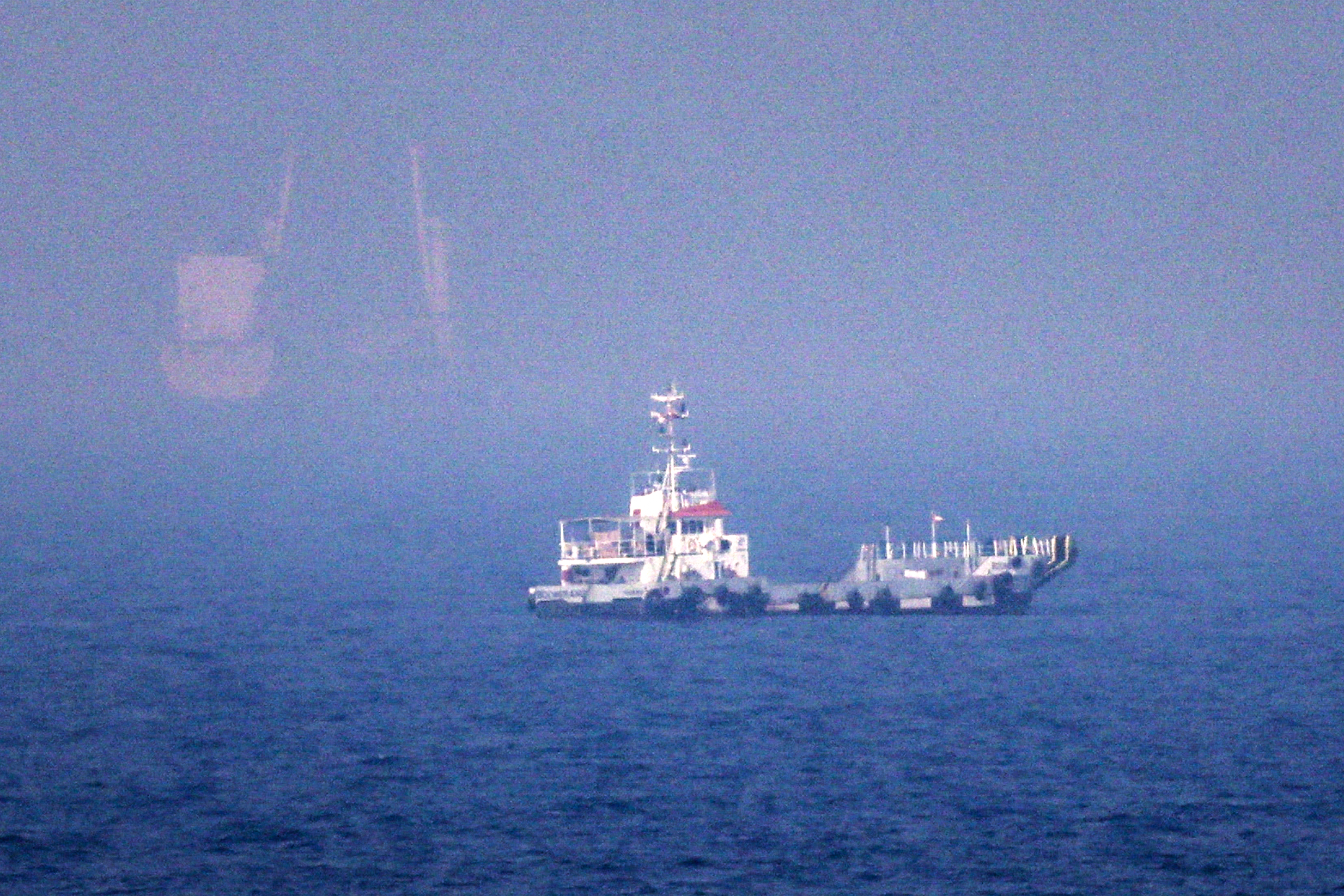 This picture shows ships sailing near the Strait of Hormuz off the eastern coast of the United Arab Emirates at Khor Fakkan on July 13, 2026.